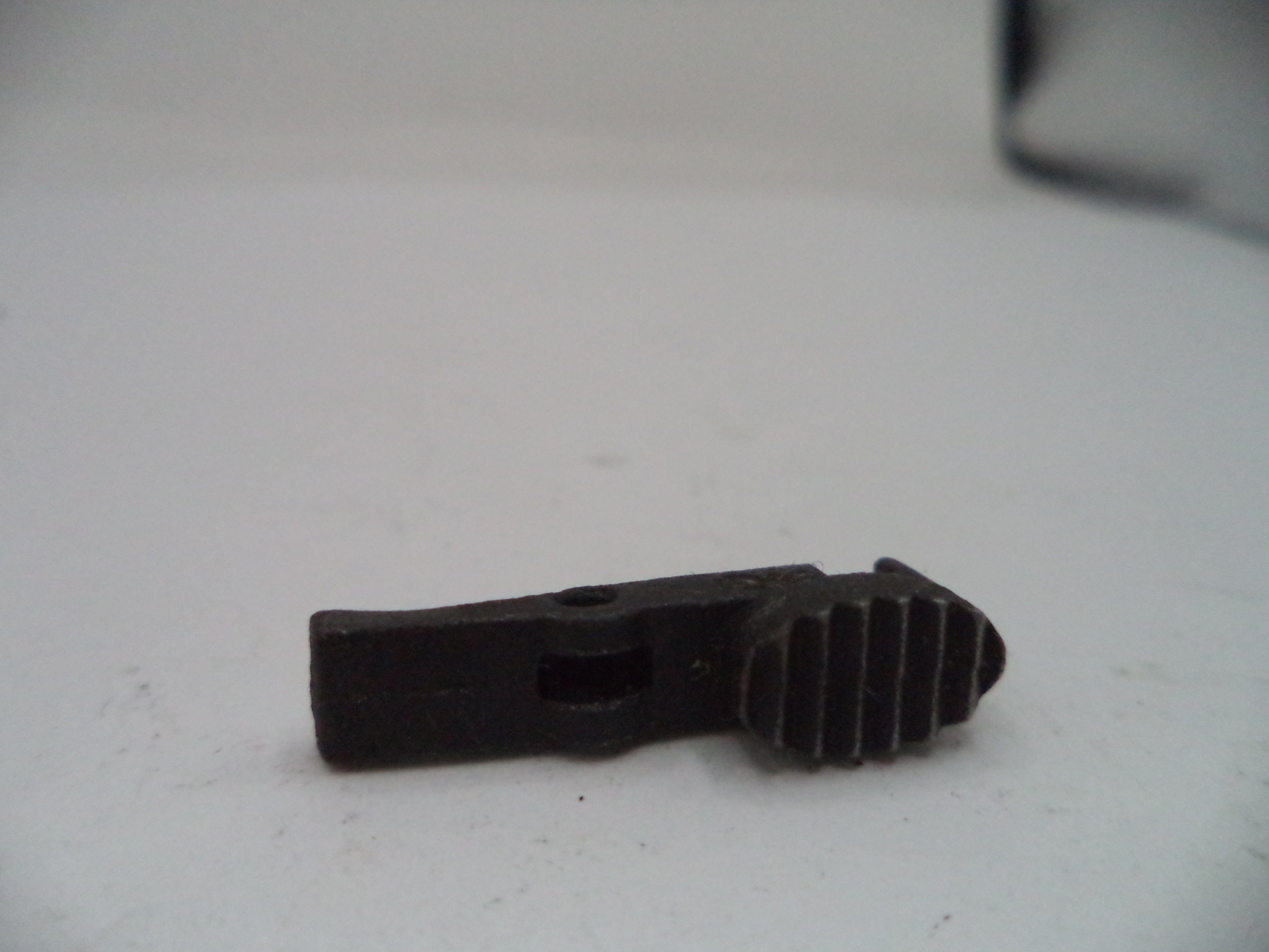 Black plastic component on a white background