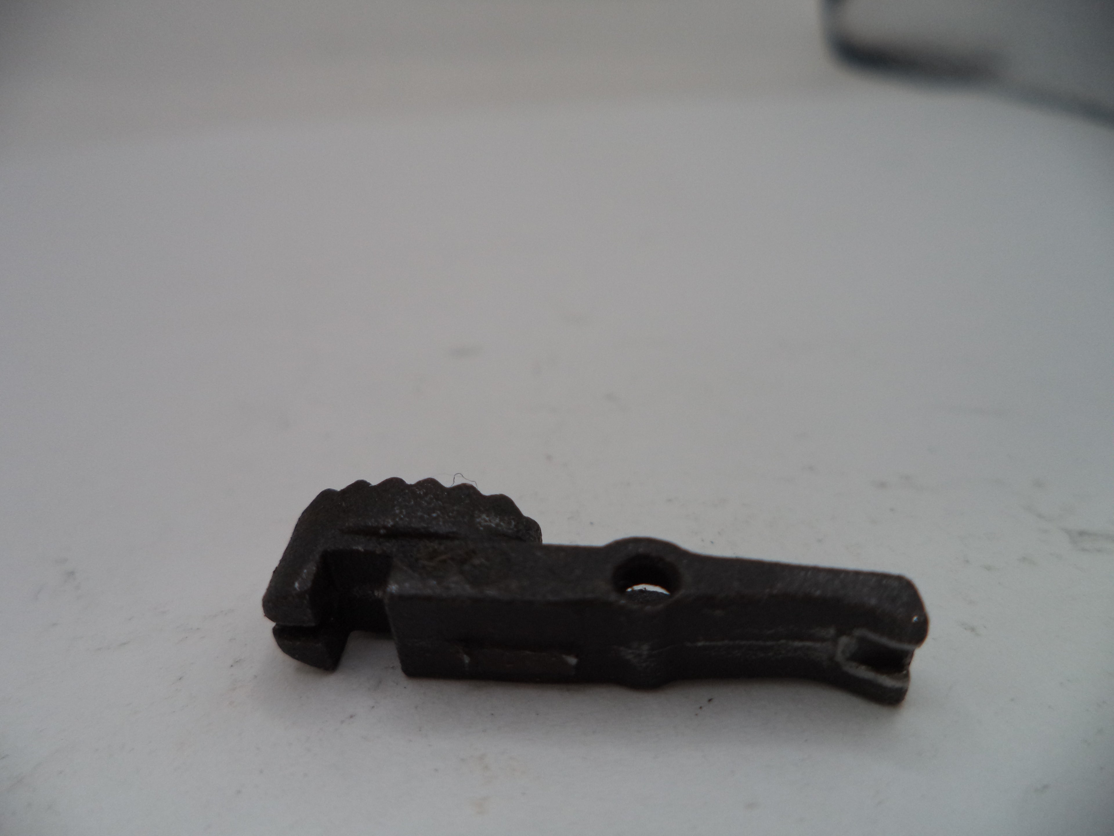 Black metal tool on a white surface