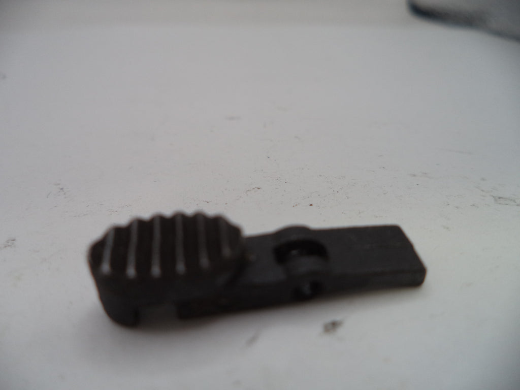 Black plastic component on a white surface