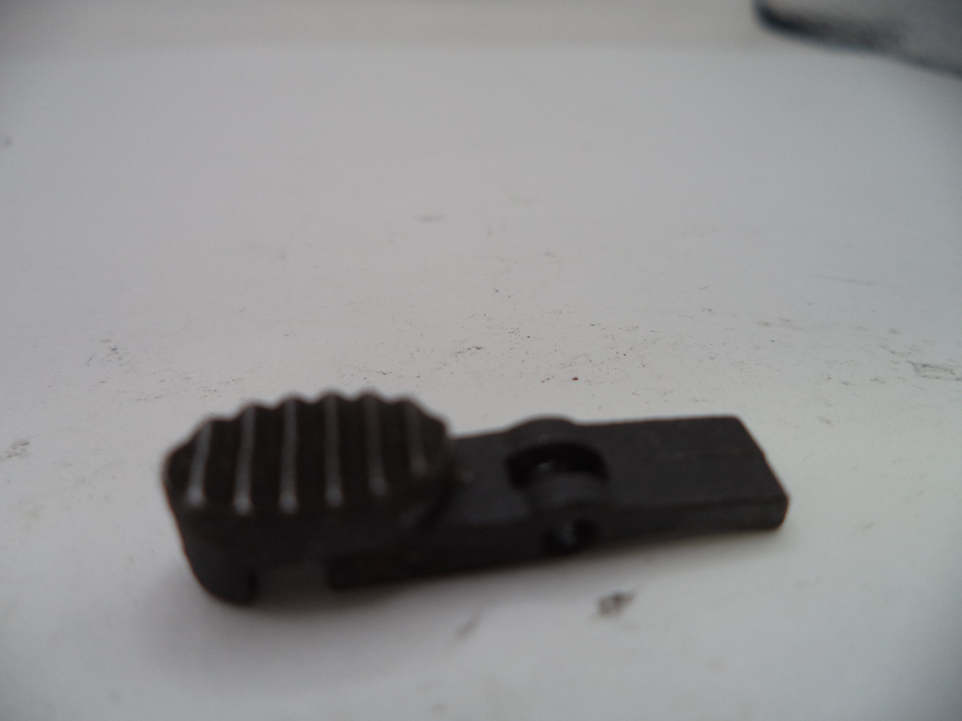 Black plastic component on a white surface