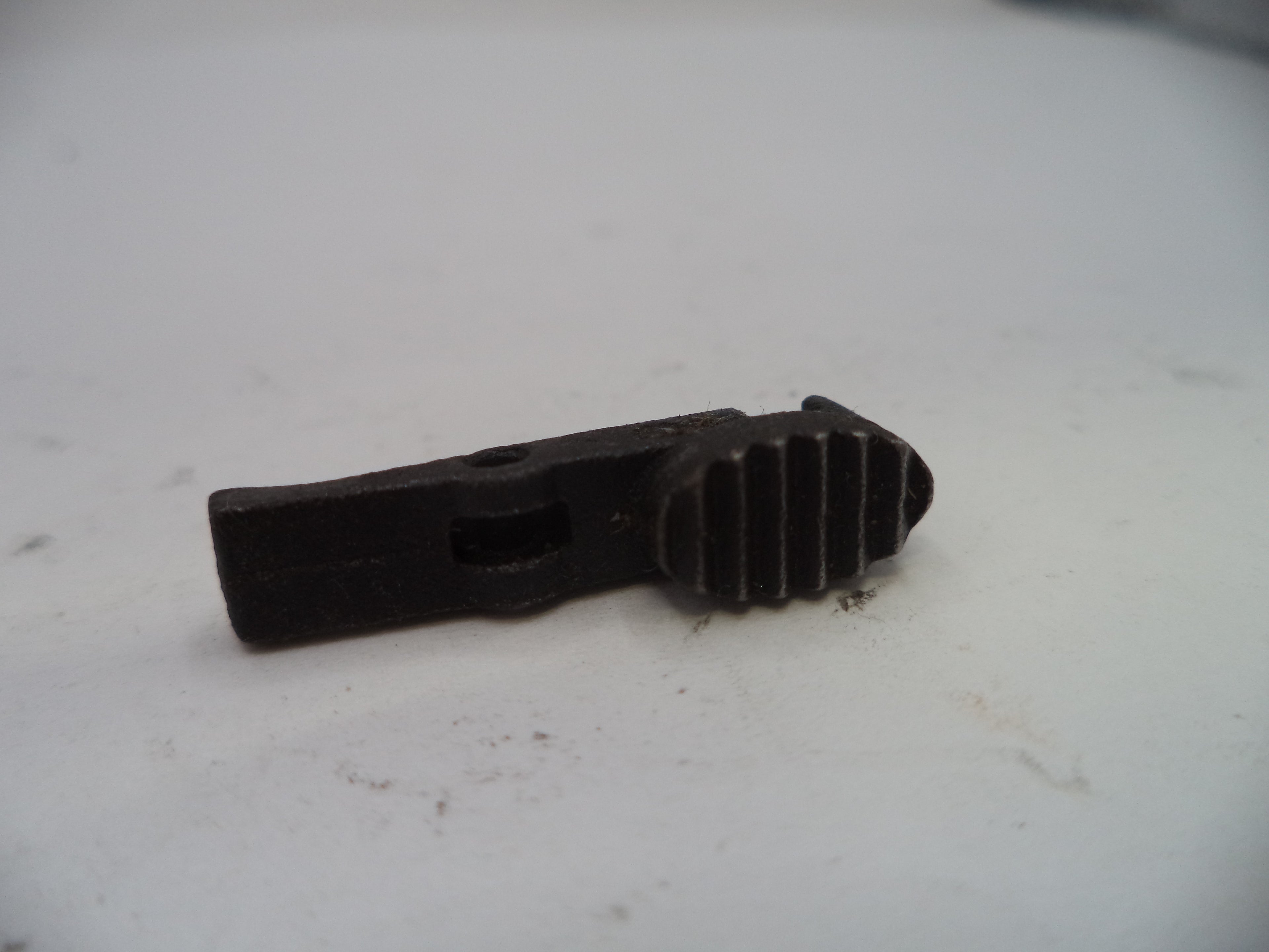 Black plastic component on a white background