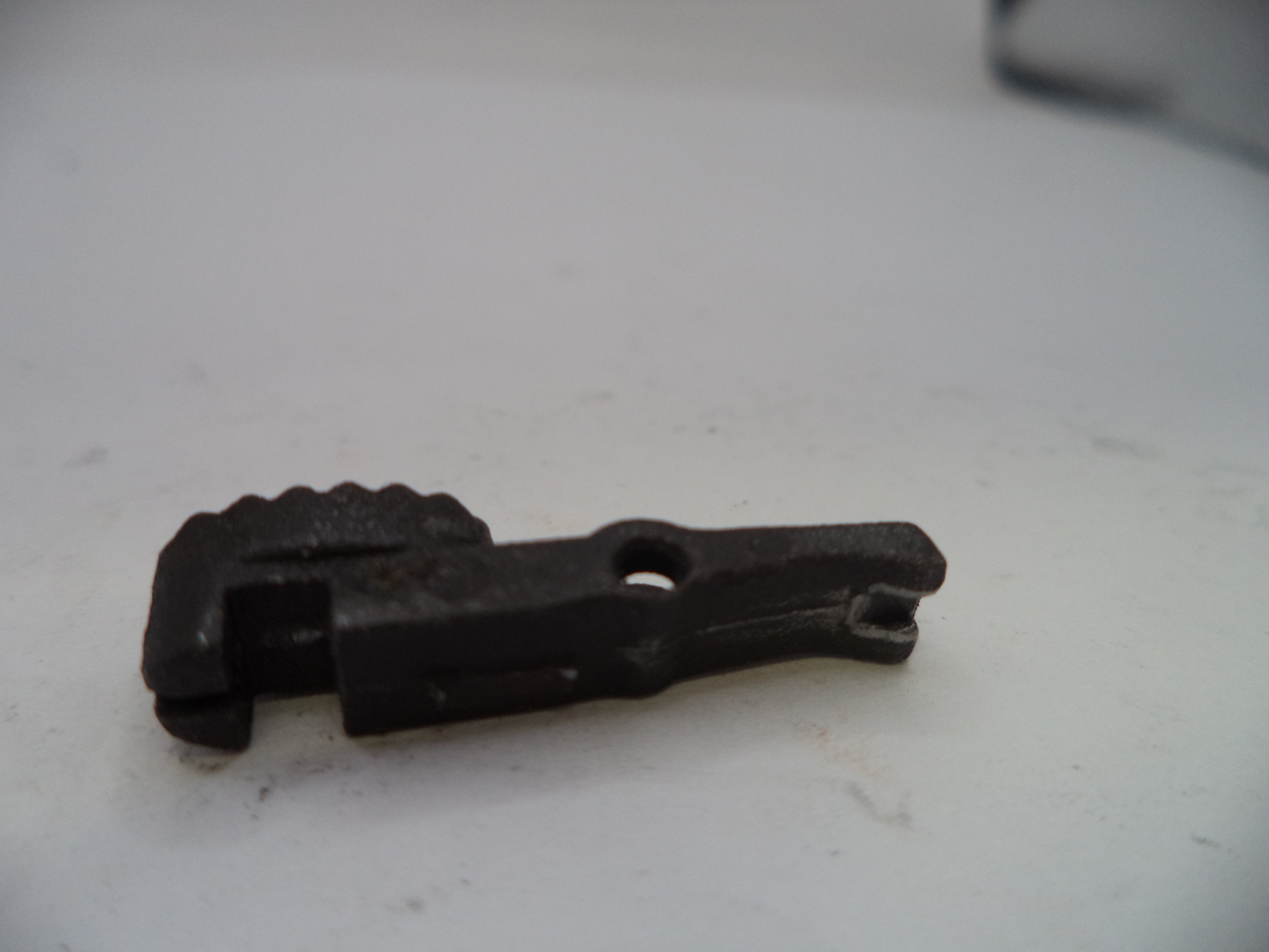 Black metal clip on a white surface