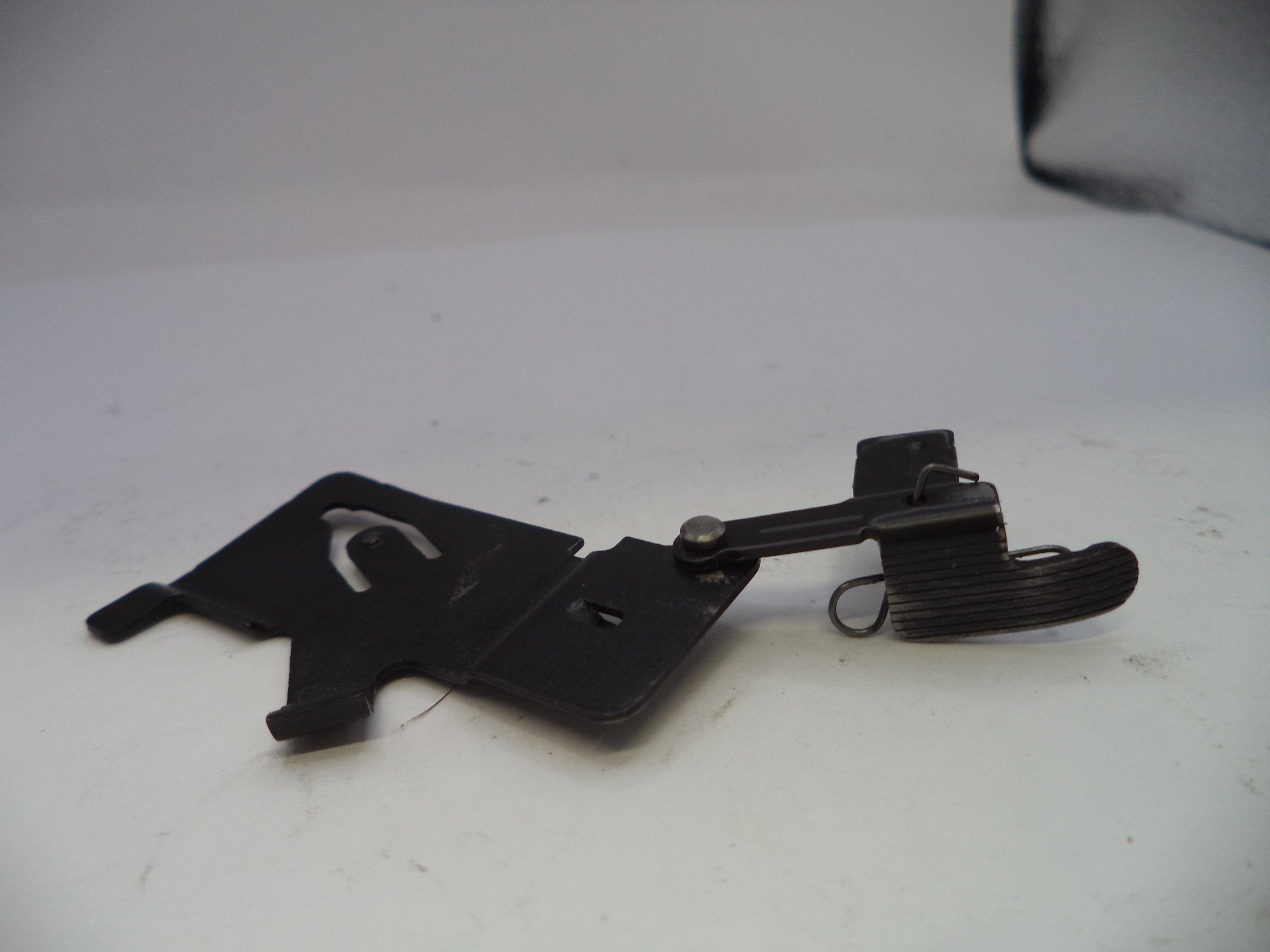 Black metal clip with spring on a white background