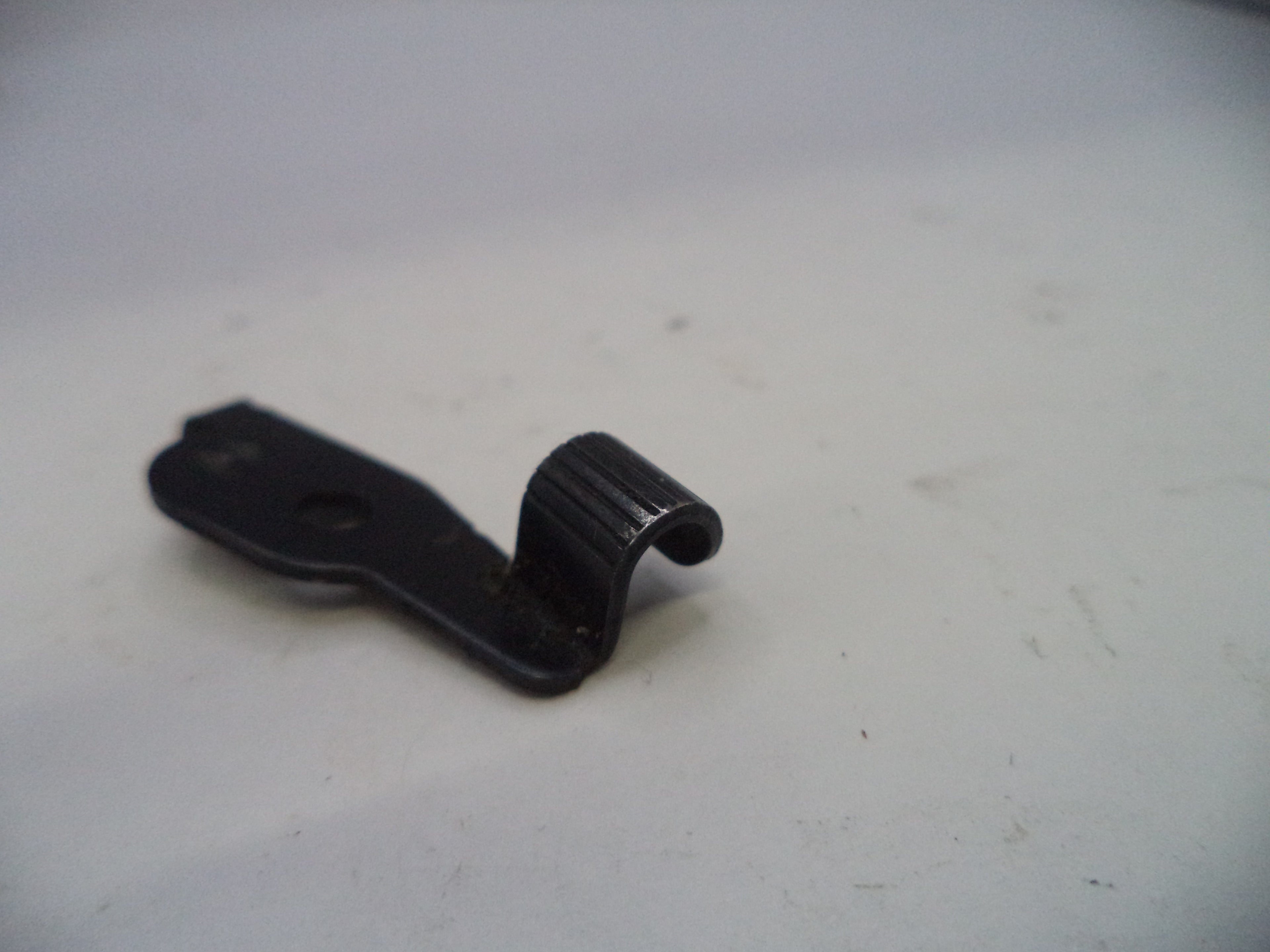 Black metal clip on a white background