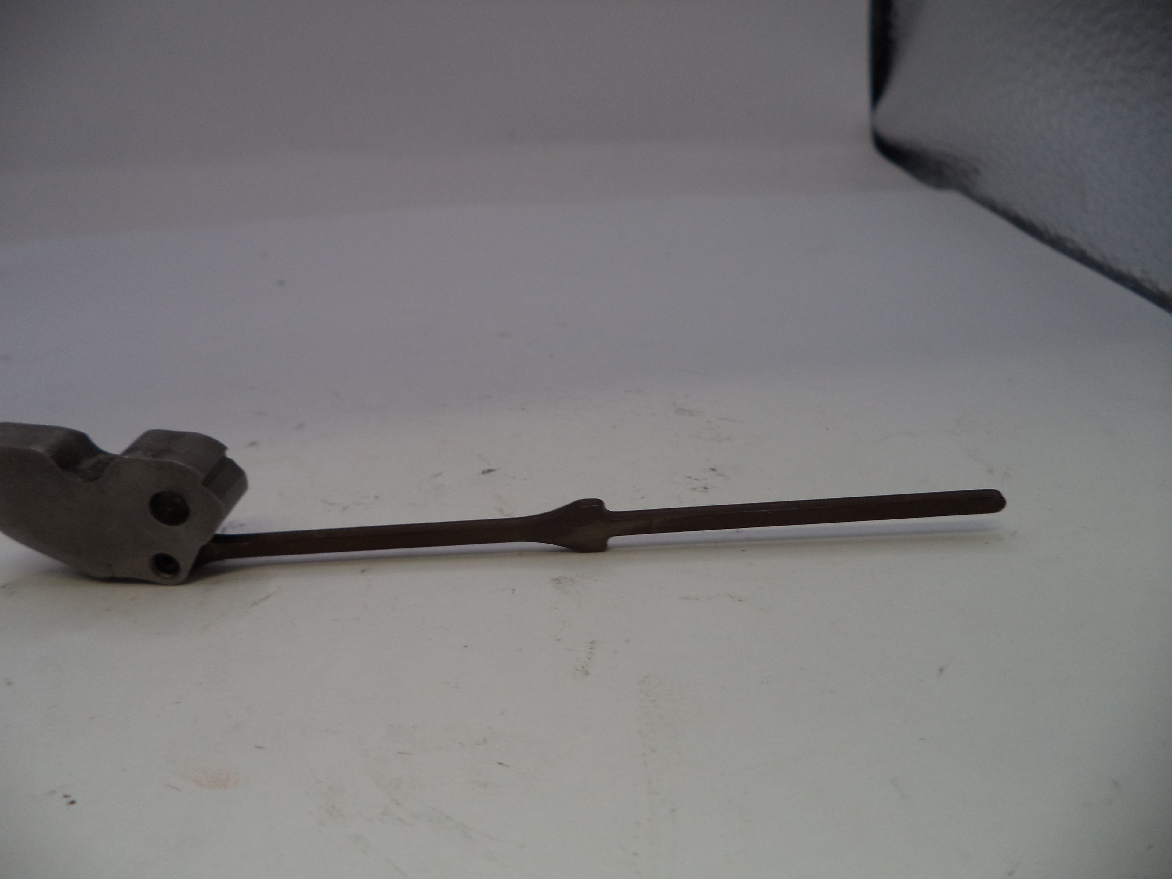 Metallic tool or component on a white background