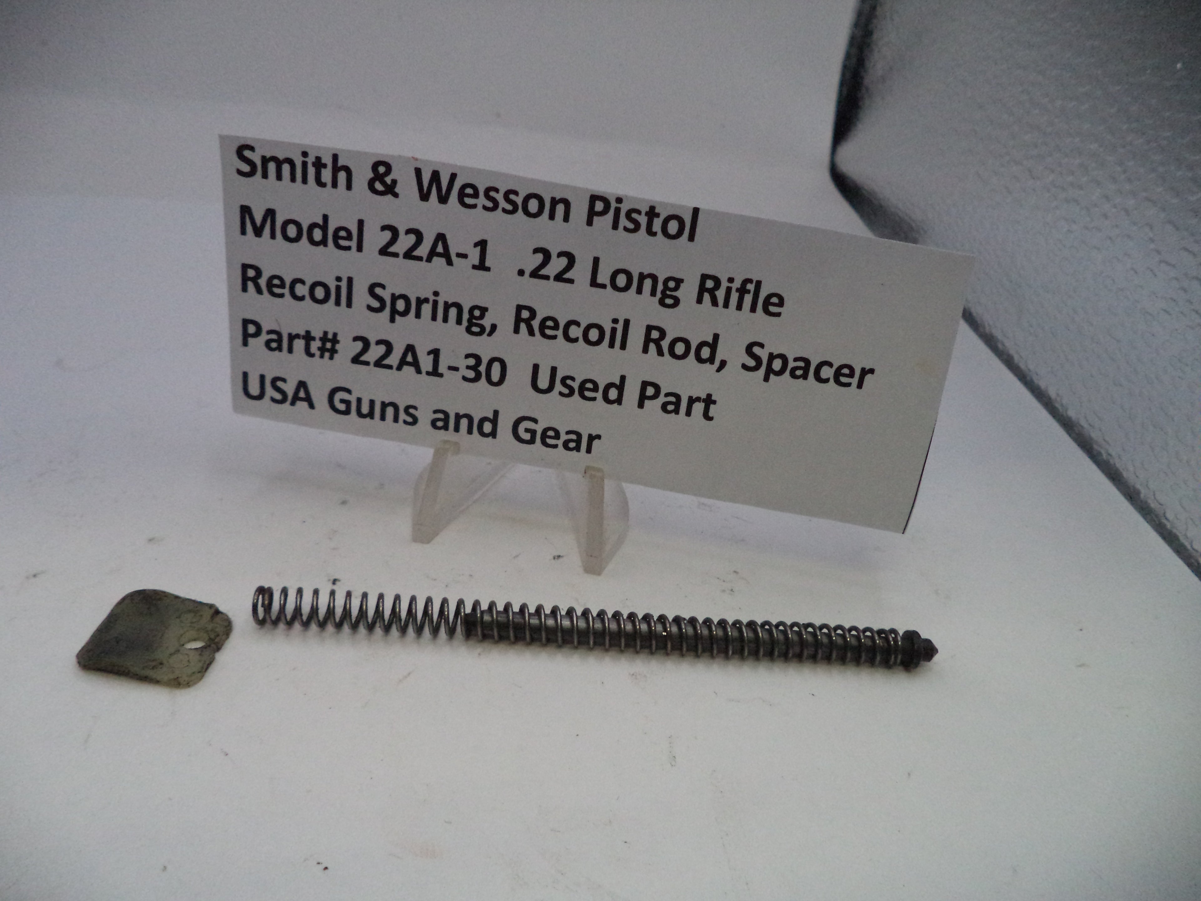 Recoil spring and rod with a label on a white background