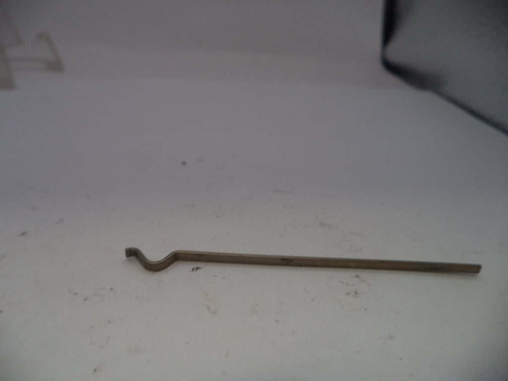 Metal tool on a white surface with a dark corner