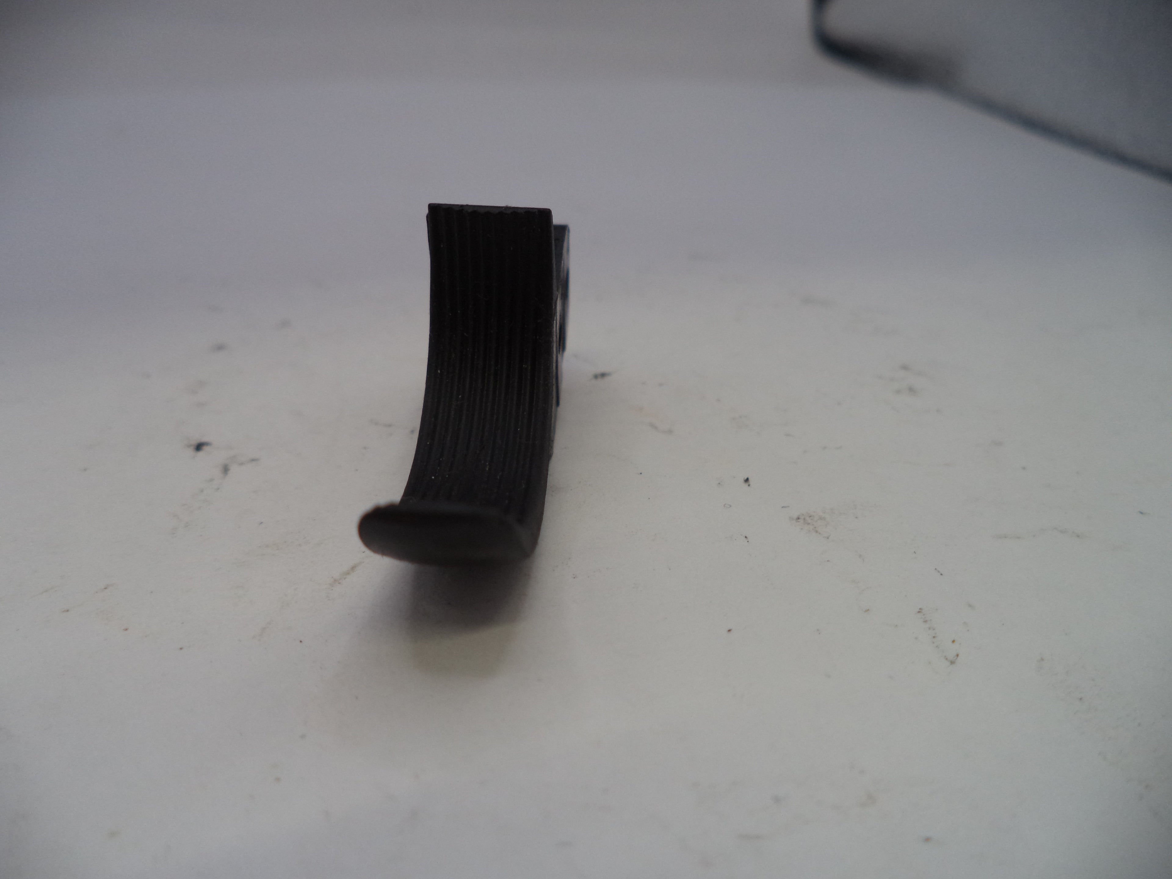 Black ribbed belt on a white surface