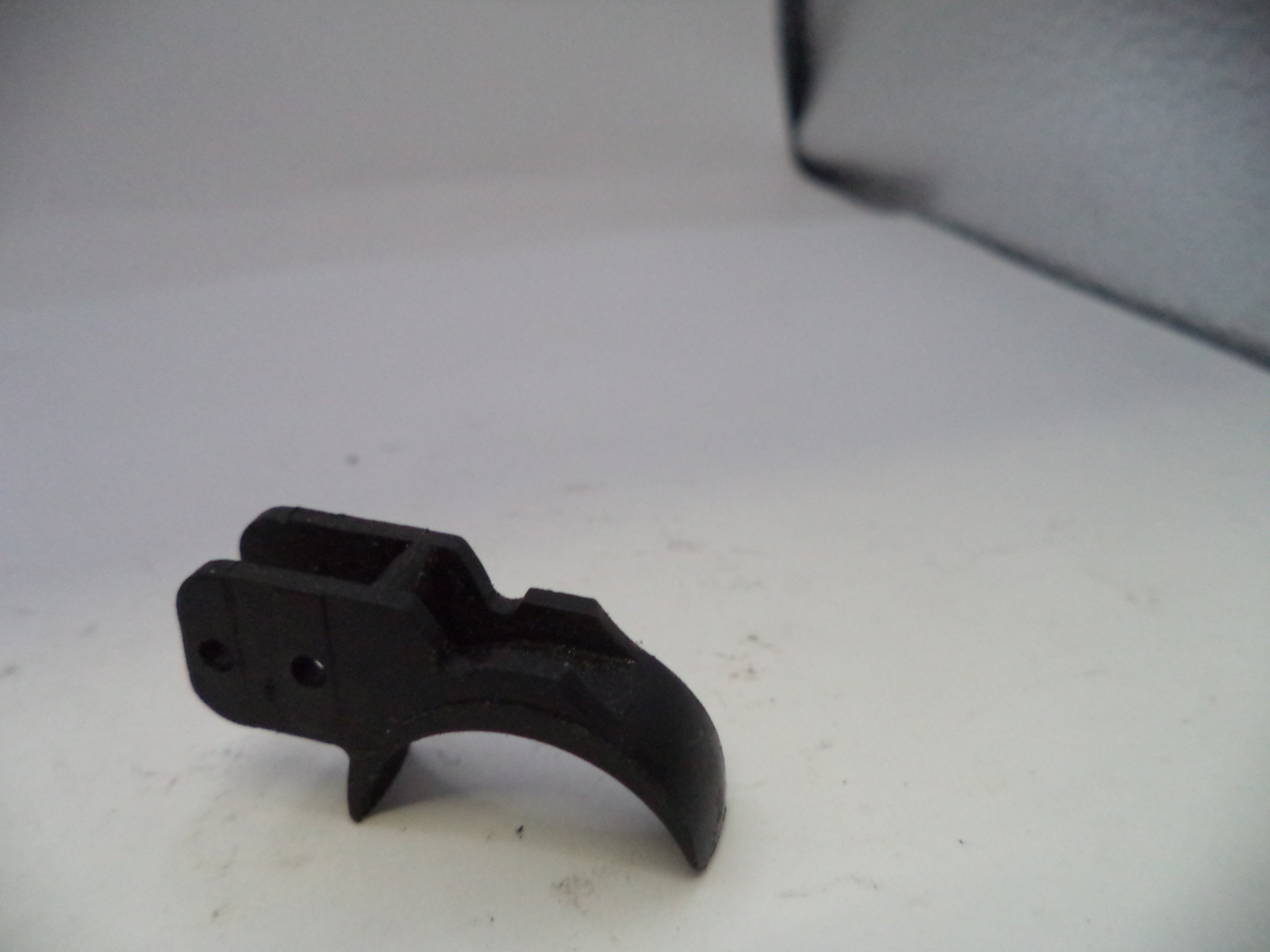Black metal component on a white surface