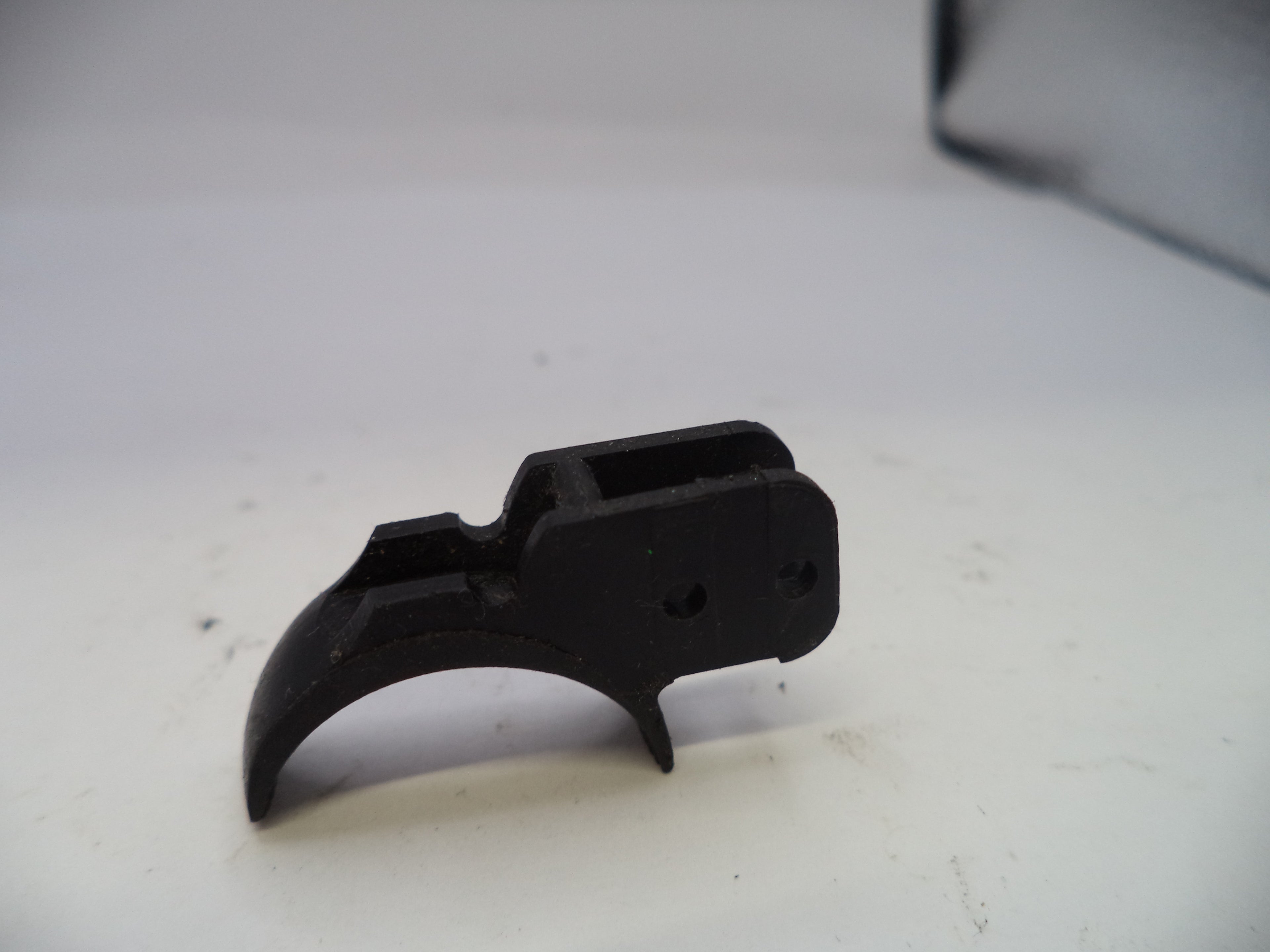 Black plastic component on a white background