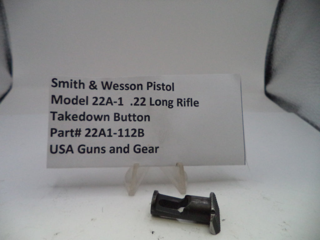 Smith & Wesson pistol takedown button with a label on a white background