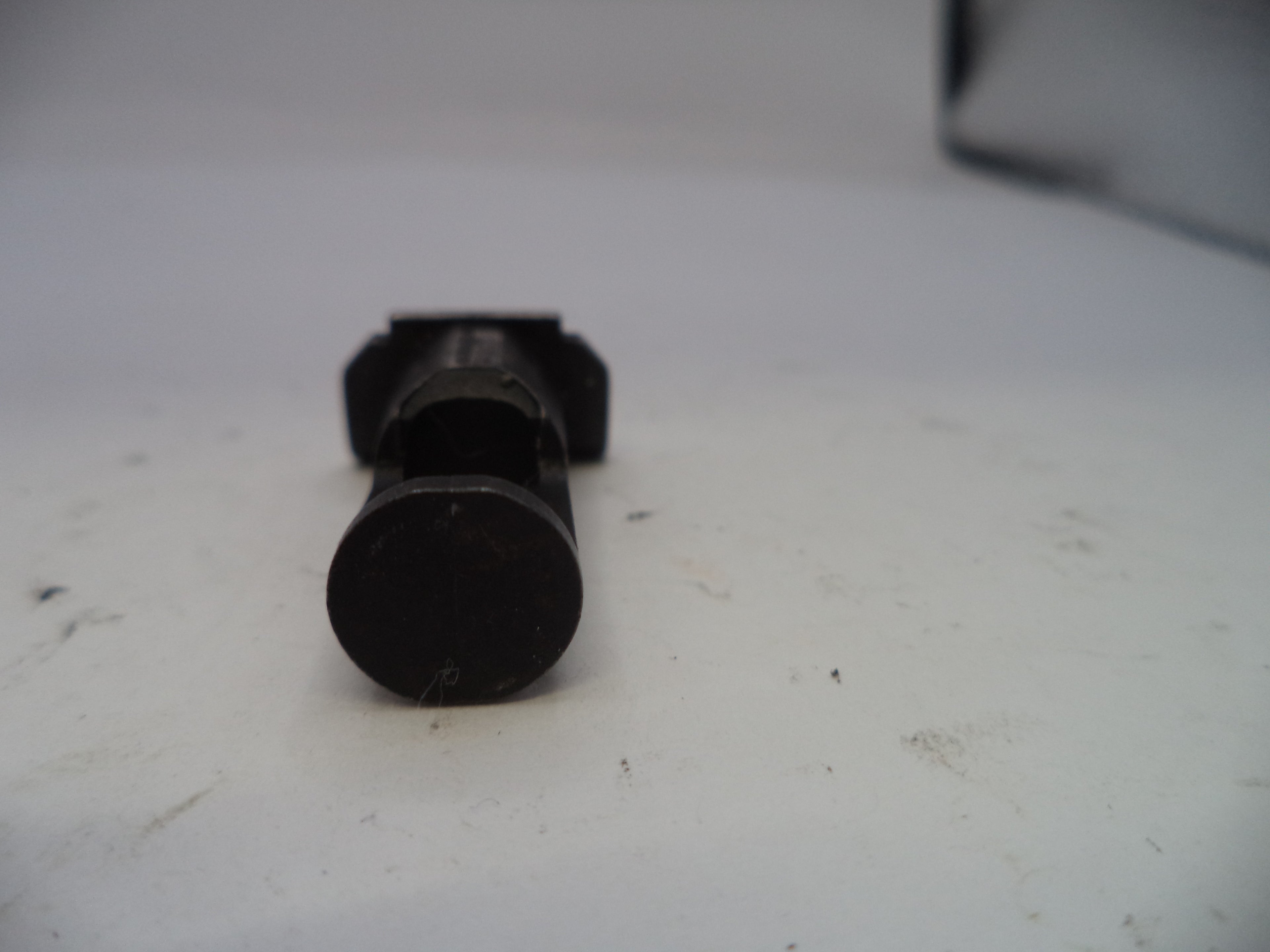 Black cylindrical object on a white surface