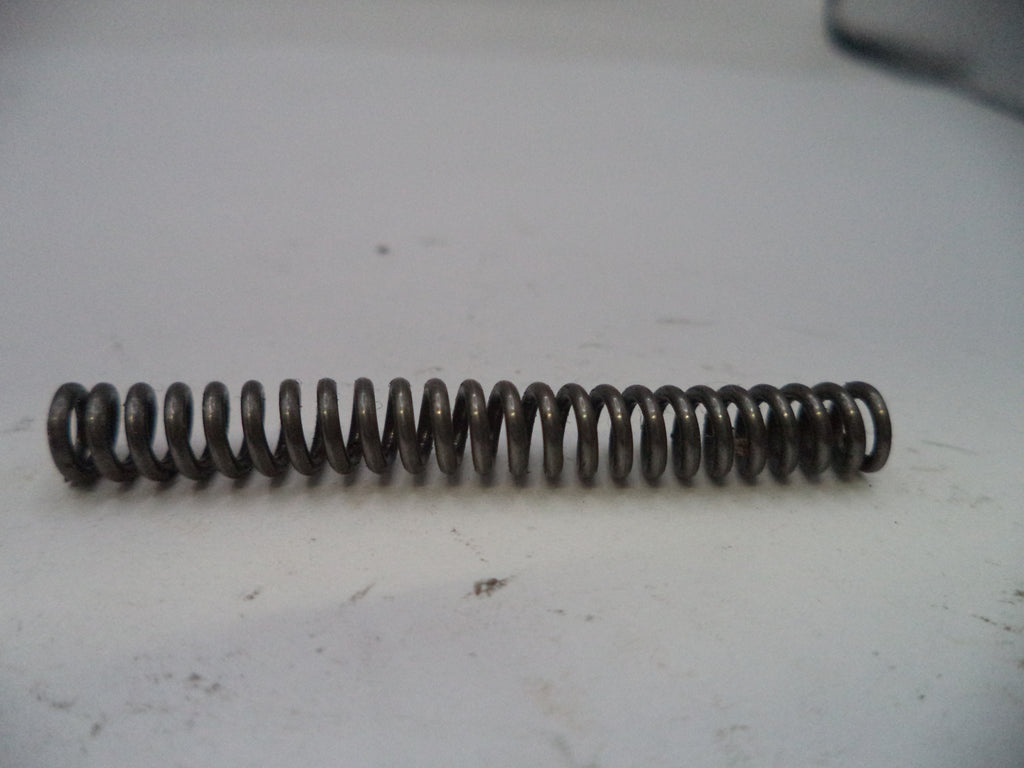 Coiled metal spring on a white surface