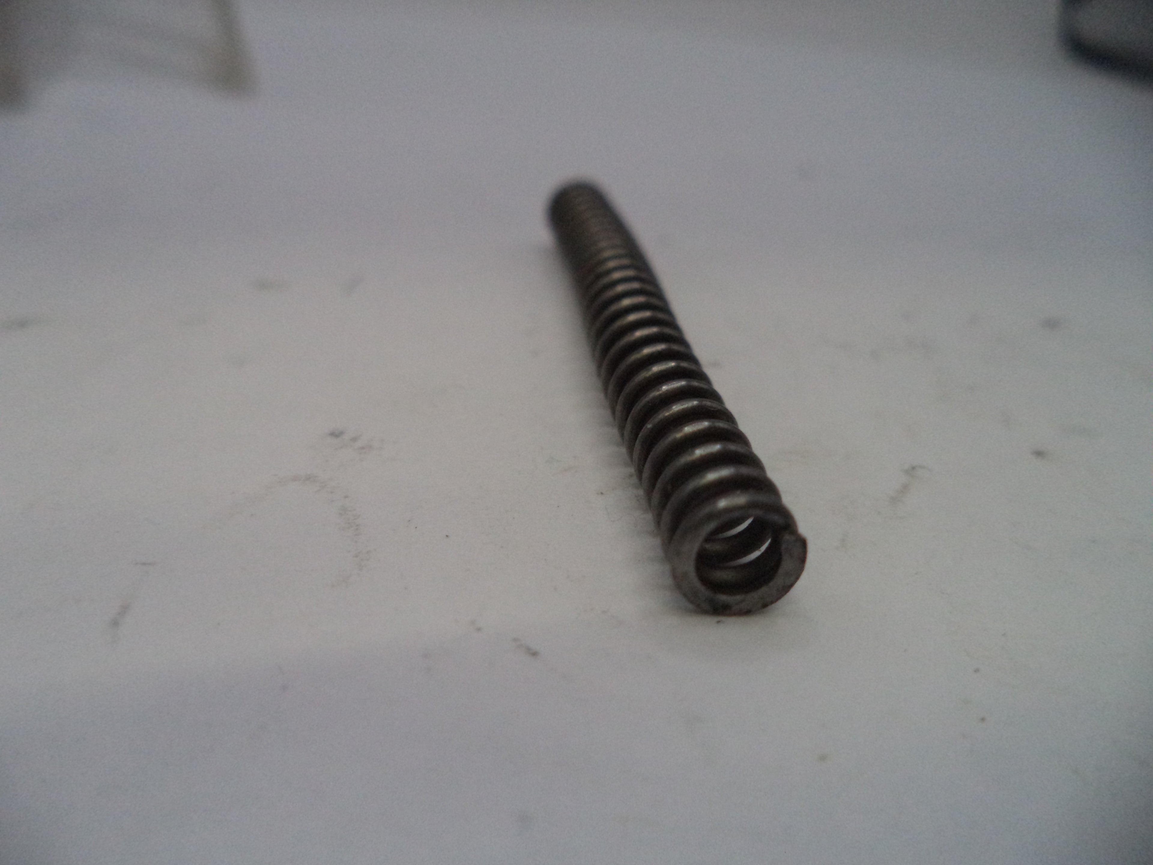Metal spring on a white surface