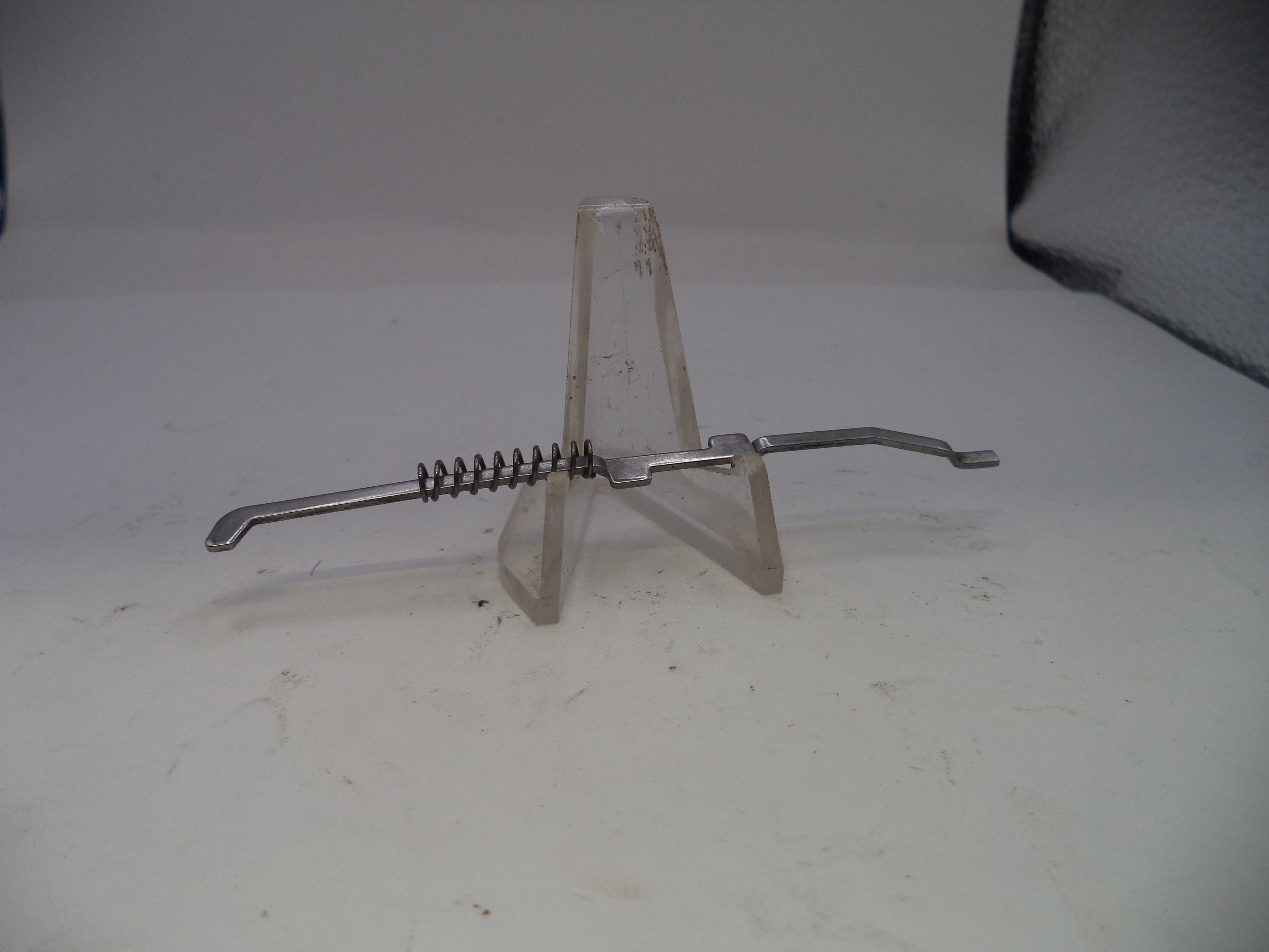 Metallic kitchen tool on a stand with a white background