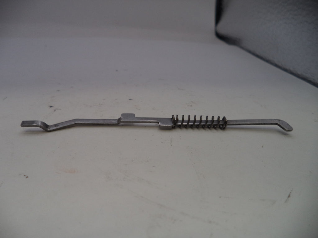 Metal spring-loaded tool on a white surface