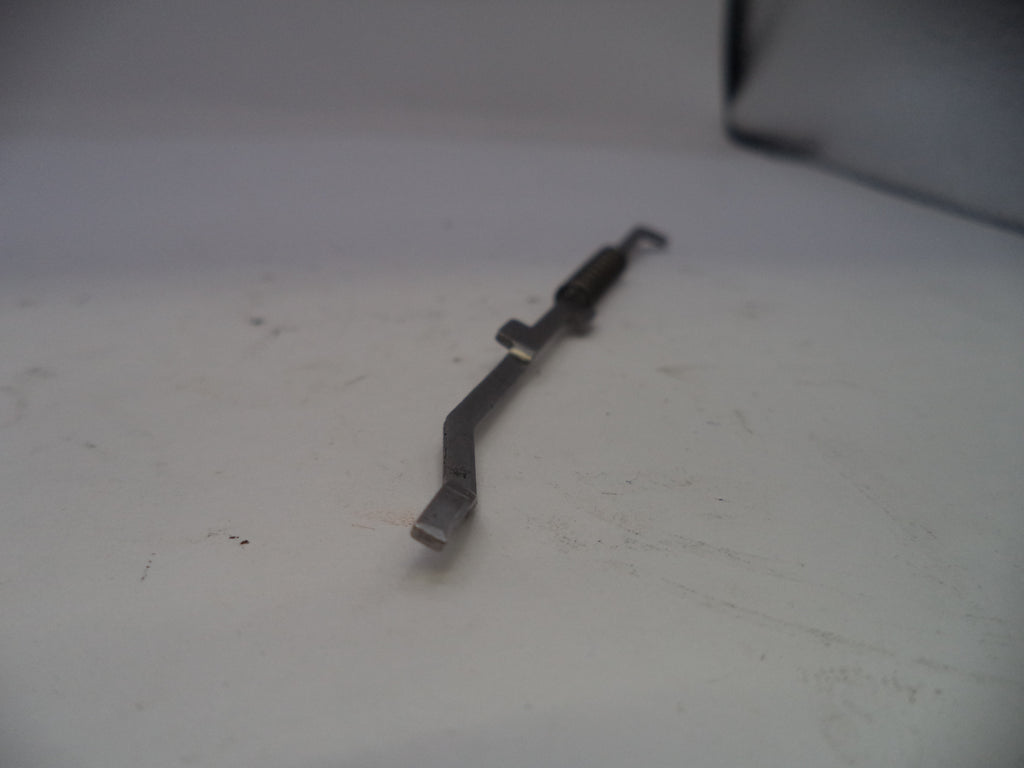 Metal tool on a white surface with a blurred background