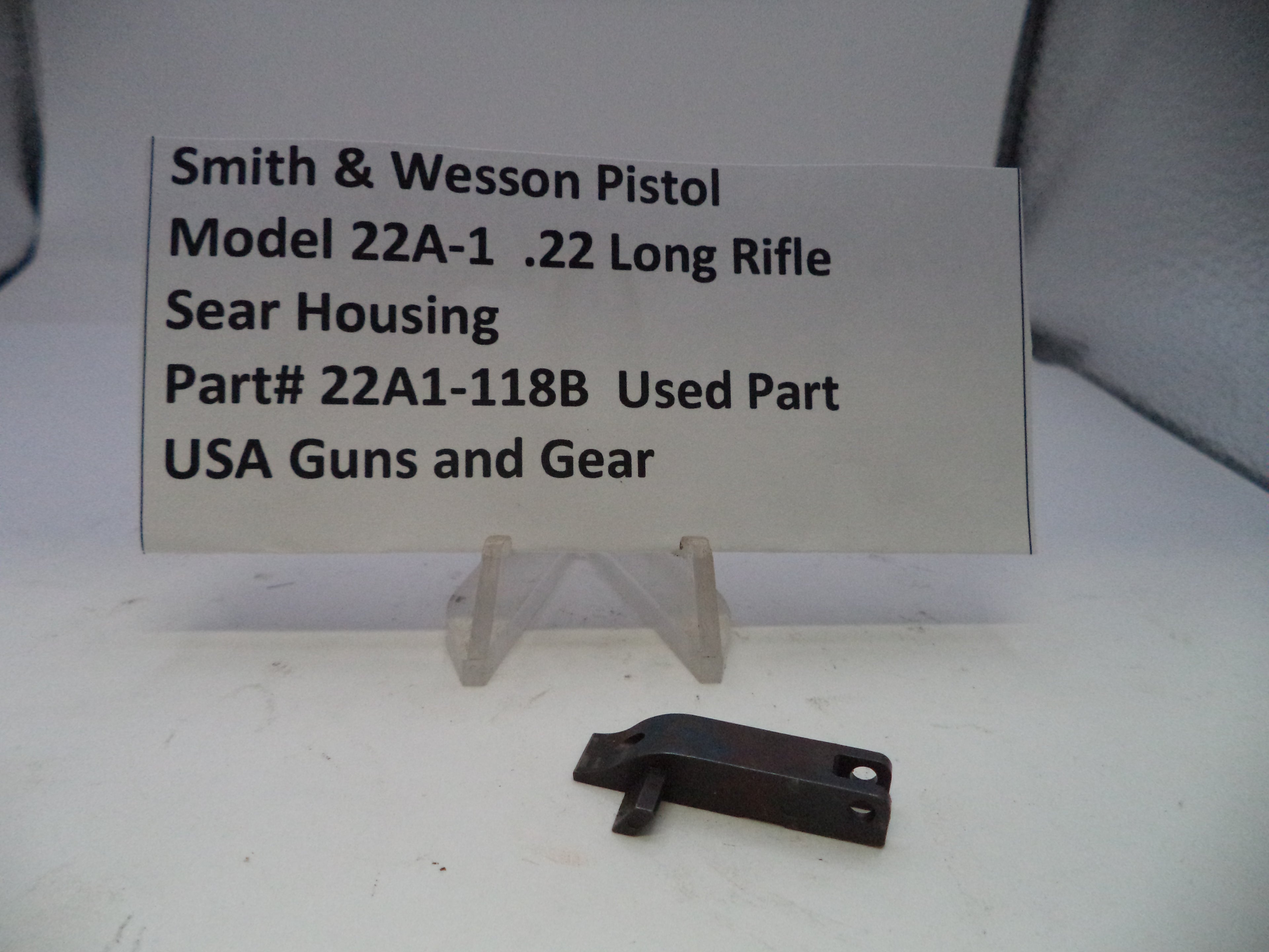 Smith & Wesson Pistol Model 22A-1 .22 Long Rifle Sear Housing on a white background with a label.