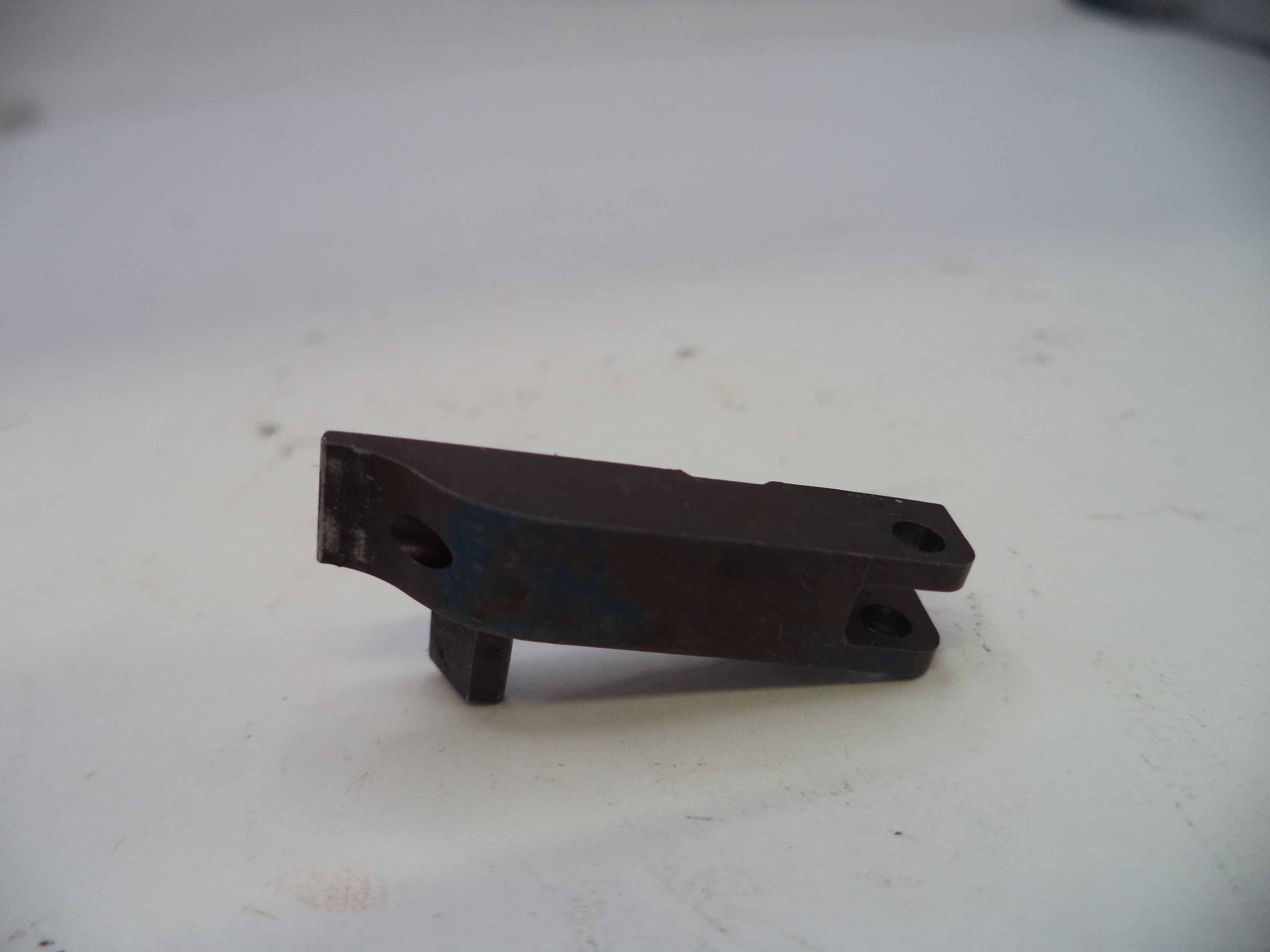 Metal bracket on a white surface