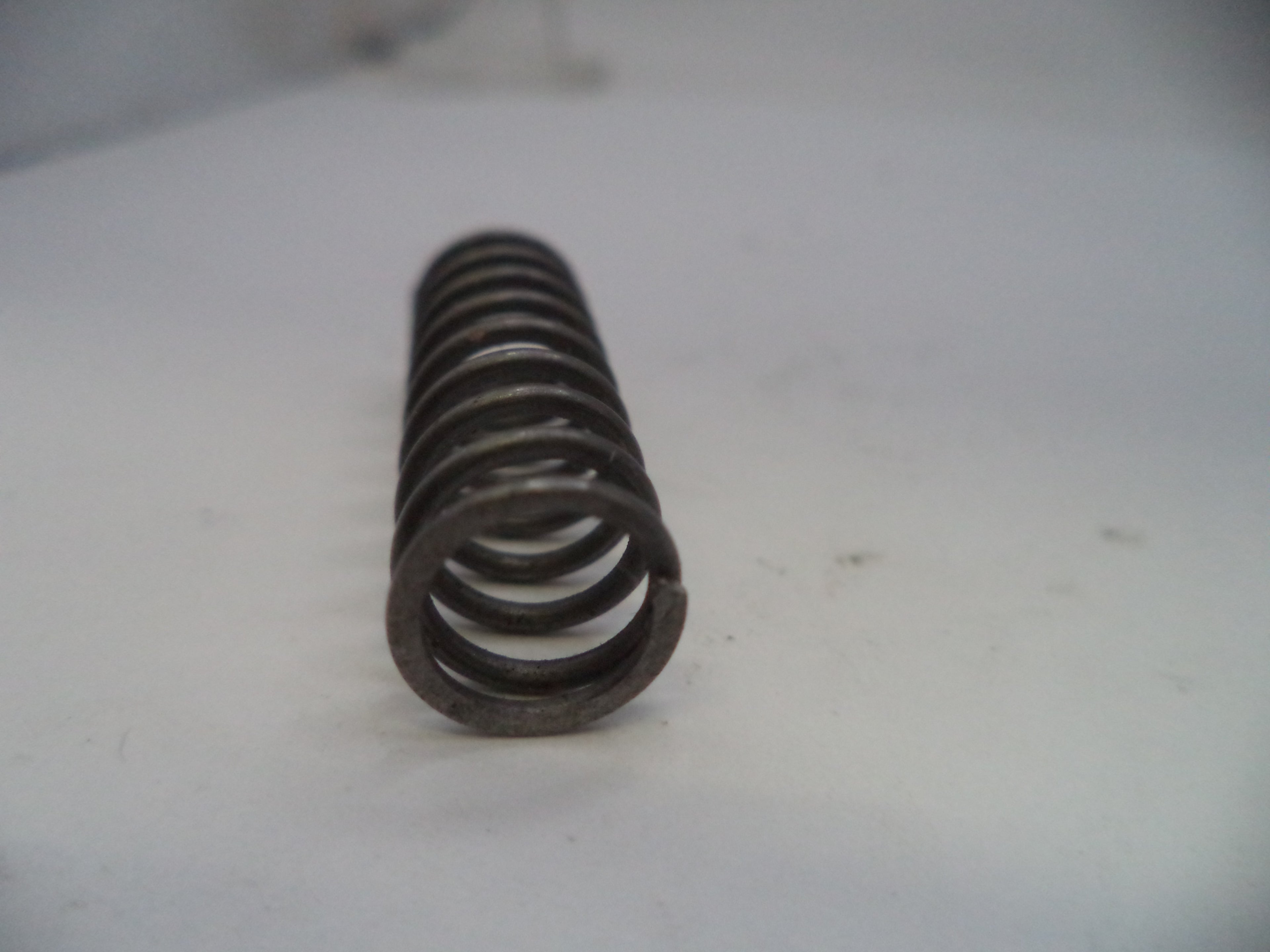 Coiled metal spring on a white background