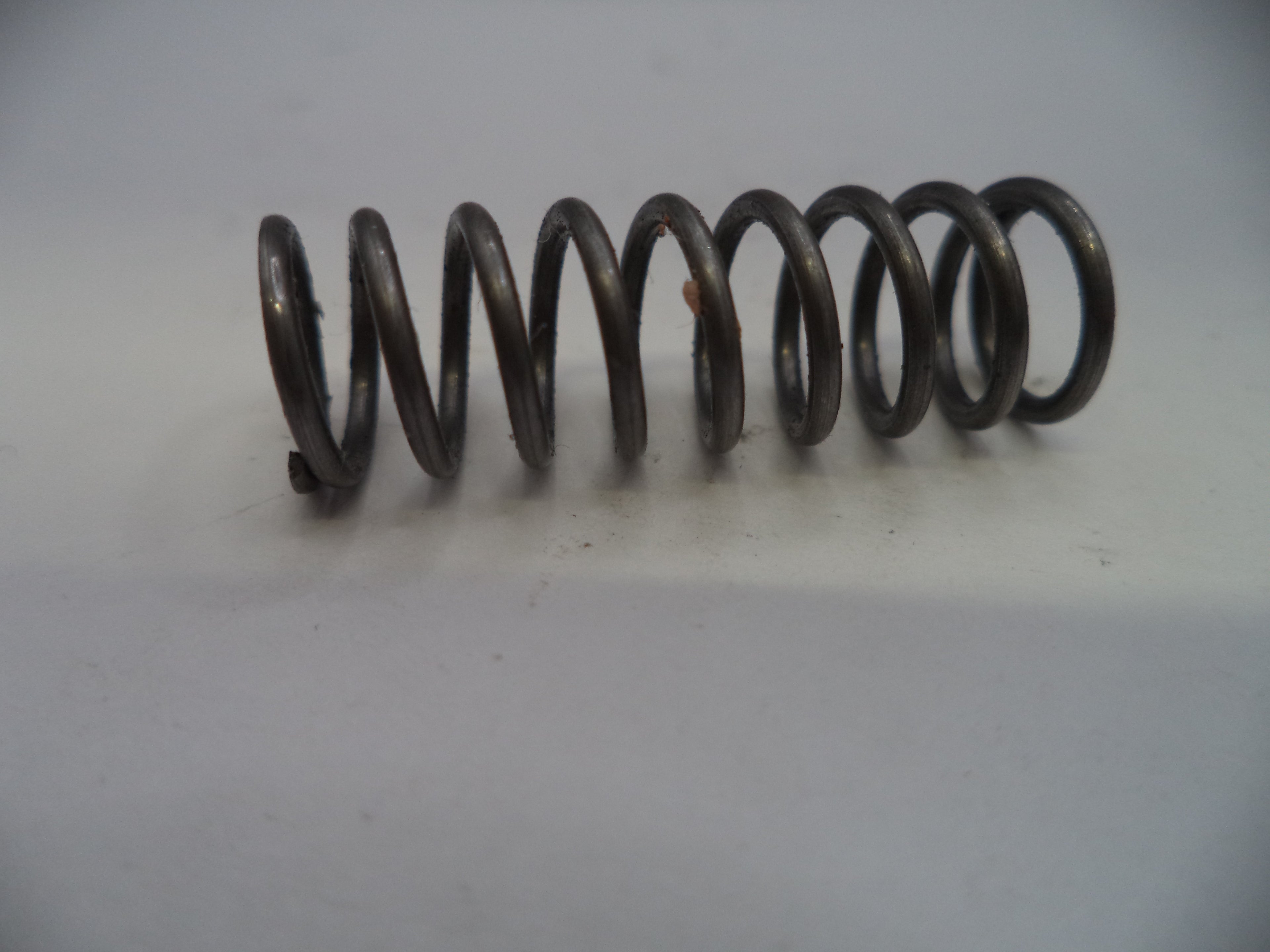 Coiled metal spring on a white background