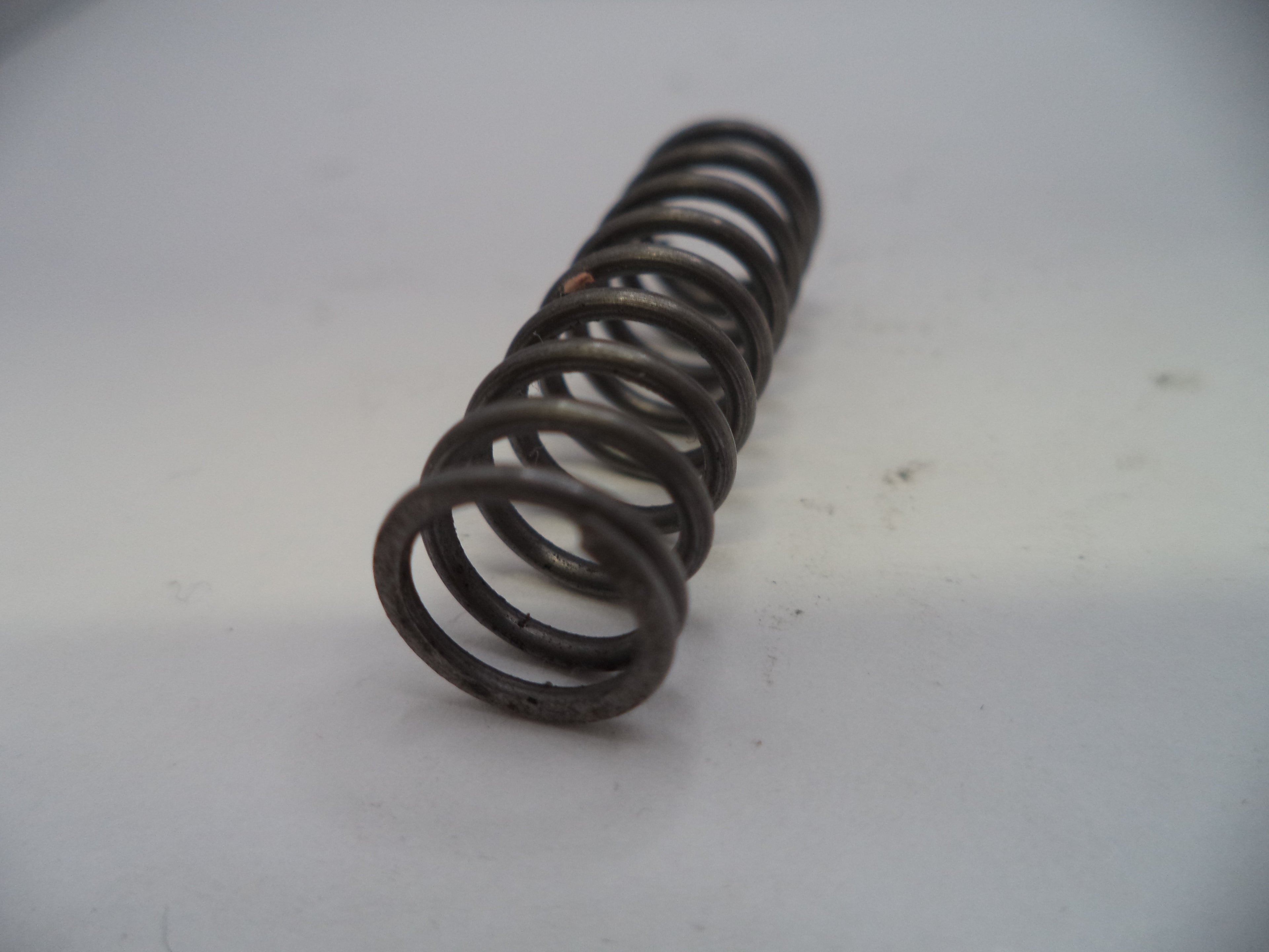 Coiled metal spring on a white background
