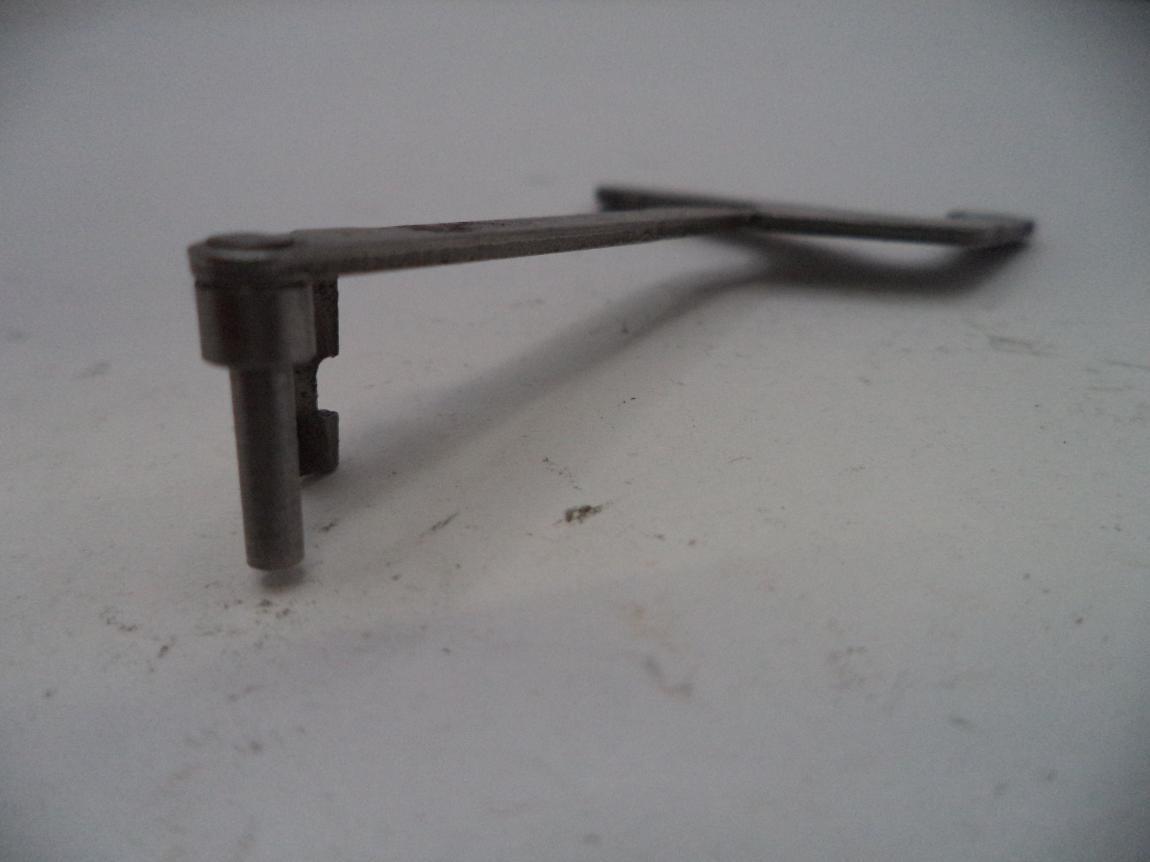 Metal key on a light gray surface