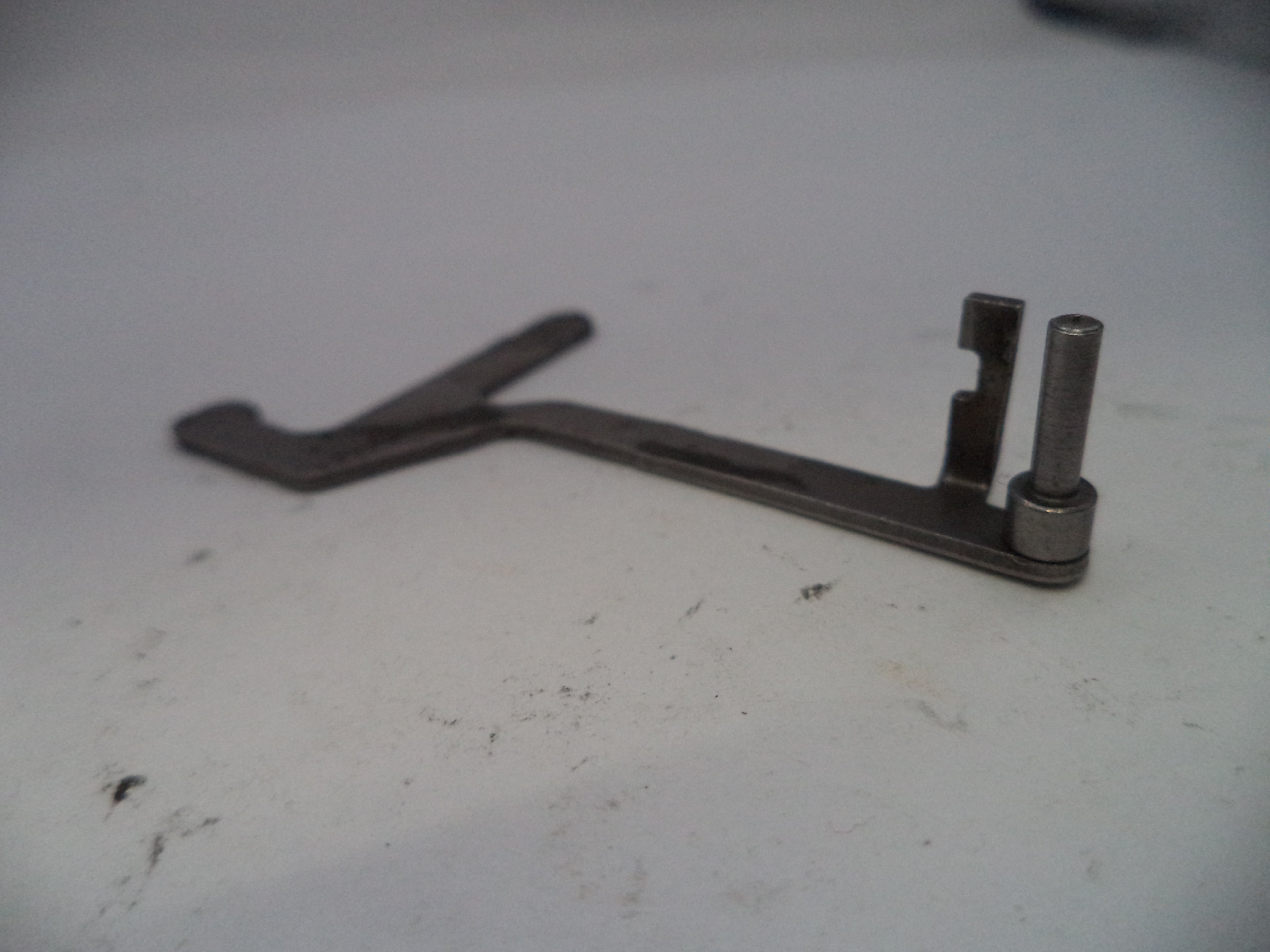 Metal tool on a white surface