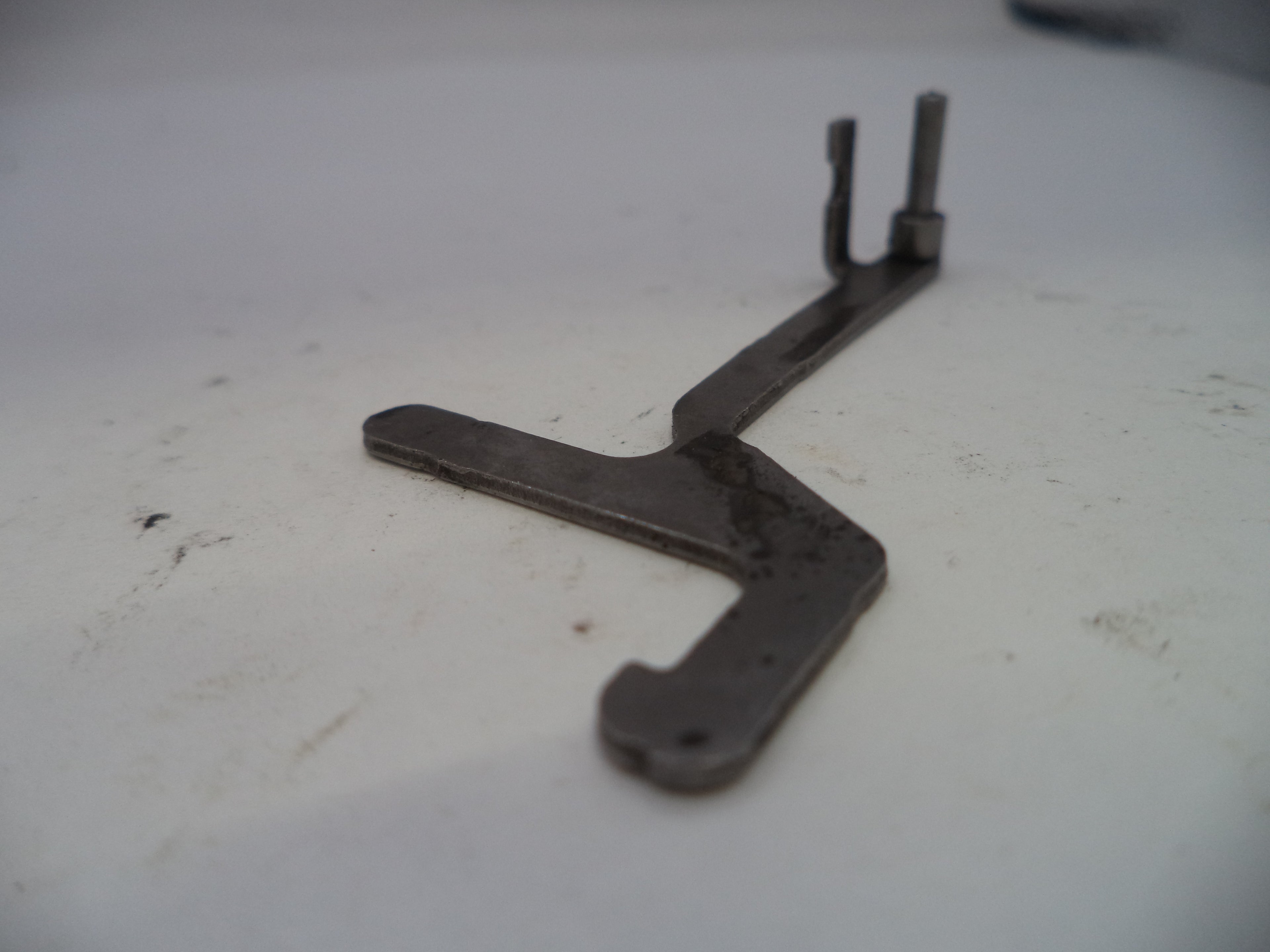 Metal tool on a white surface