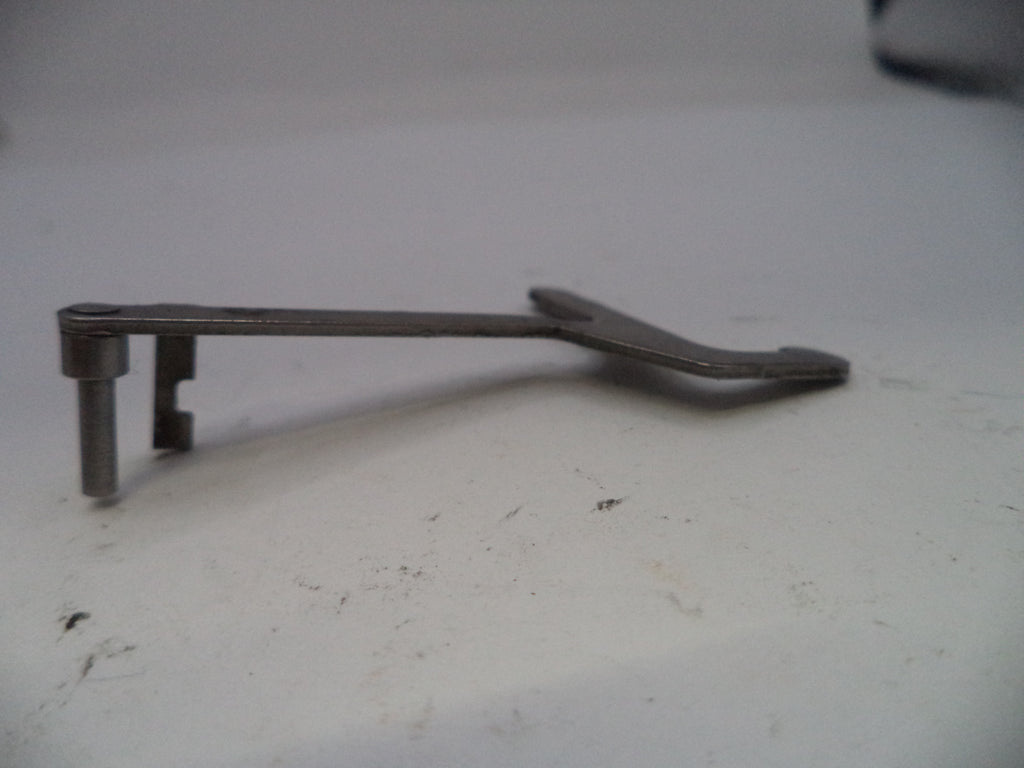 Metal lever or handle on a white surface