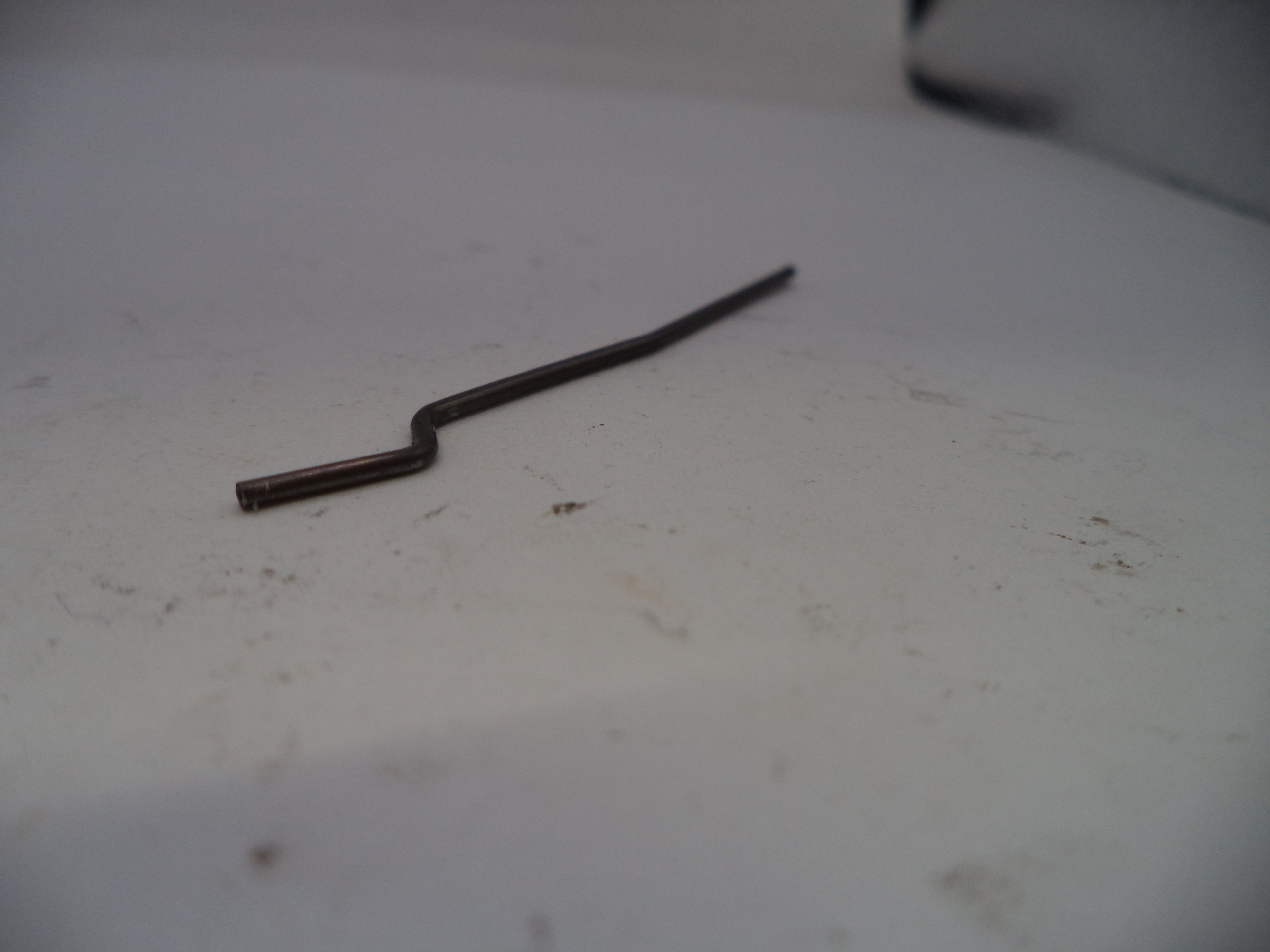 Metallic object on a white surface