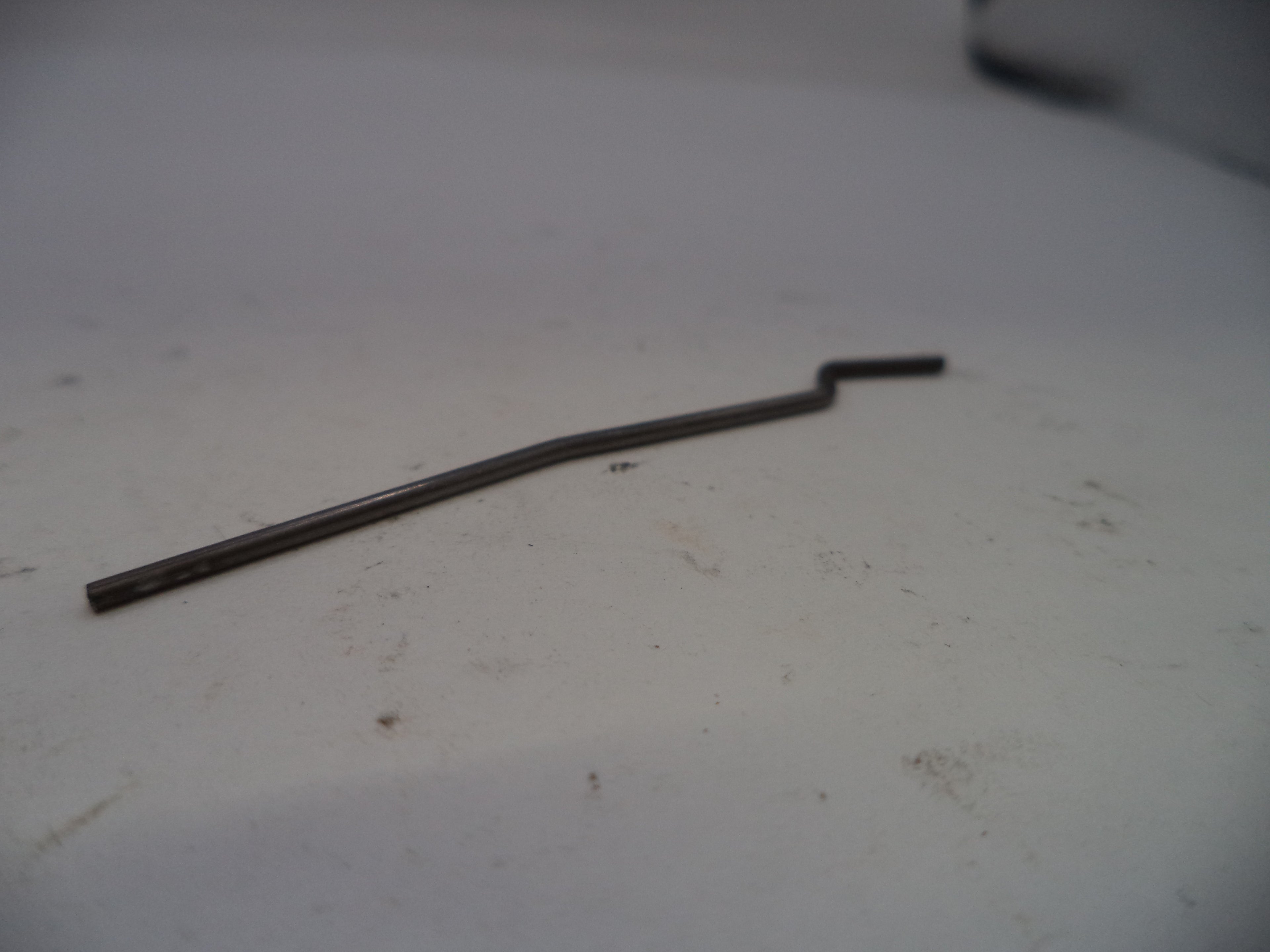 Metal rod on a dirty white surface