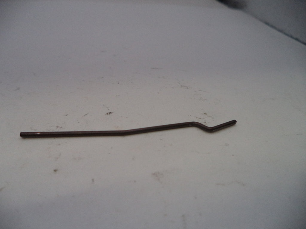 Metallic curved rod on a white surface