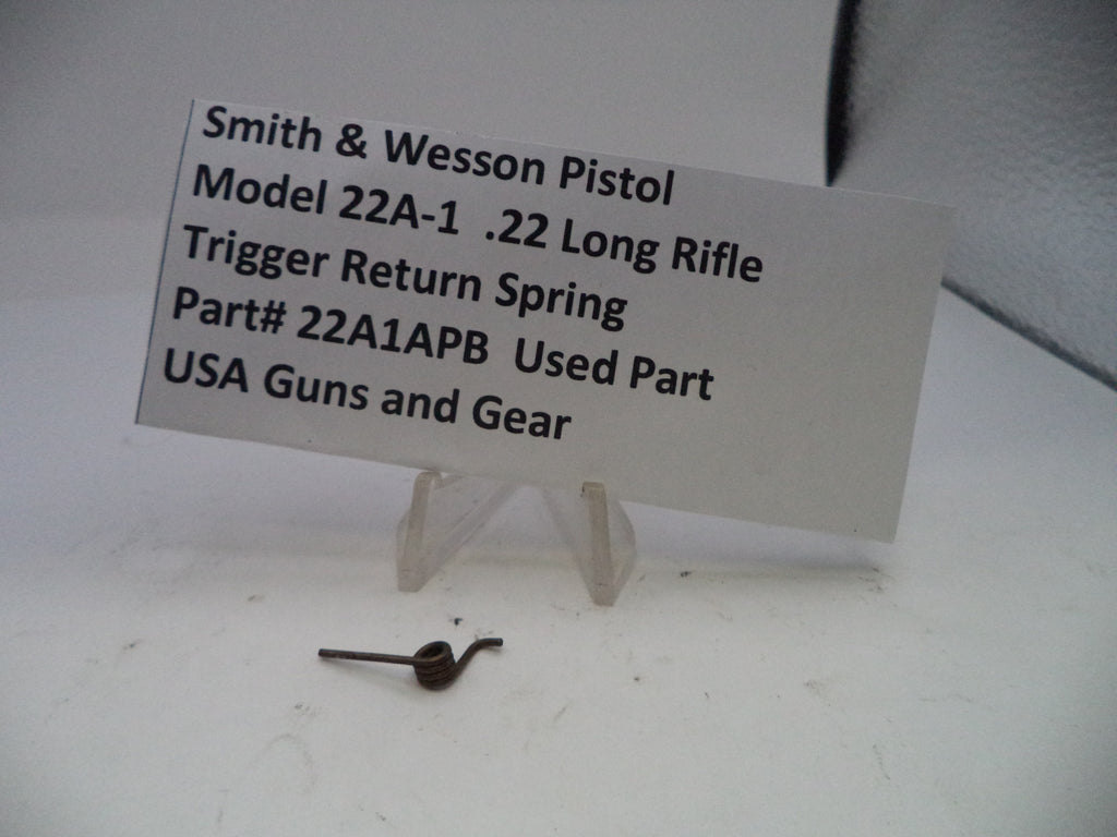 Smith & Wesson pistol trigger return spring with a label on a white background
