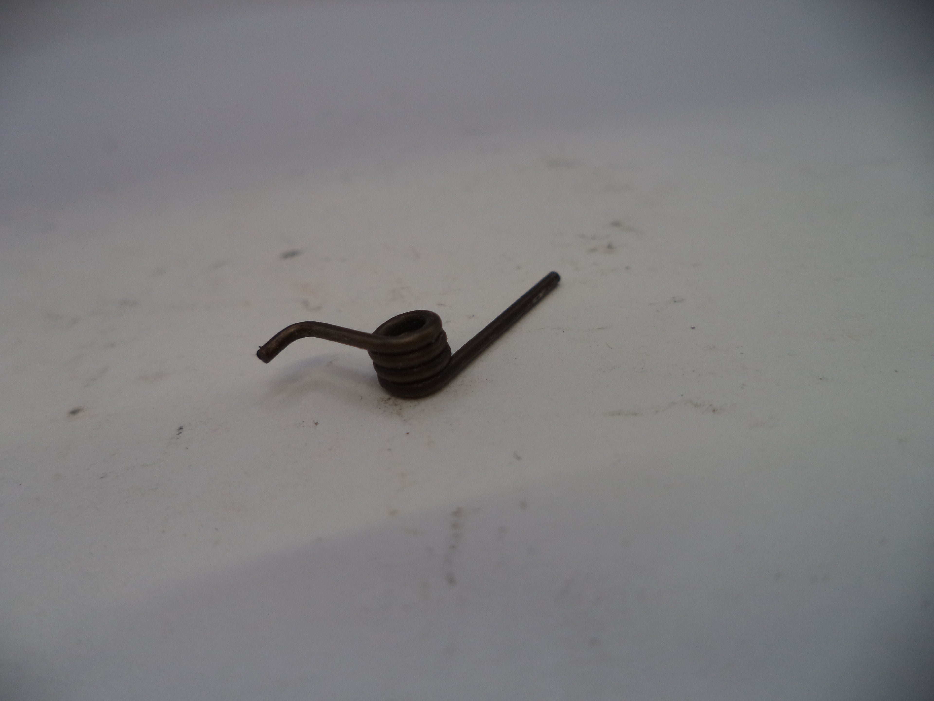 Small metal object on a white surface