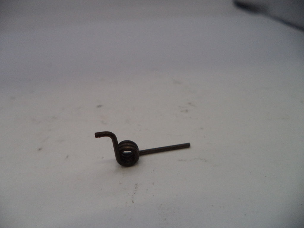 Small metal spring on a white surface