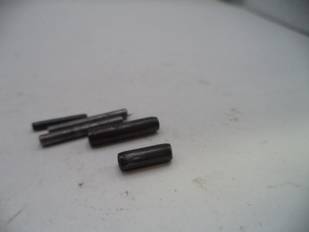 Four black cylindrical objects on a white surface
