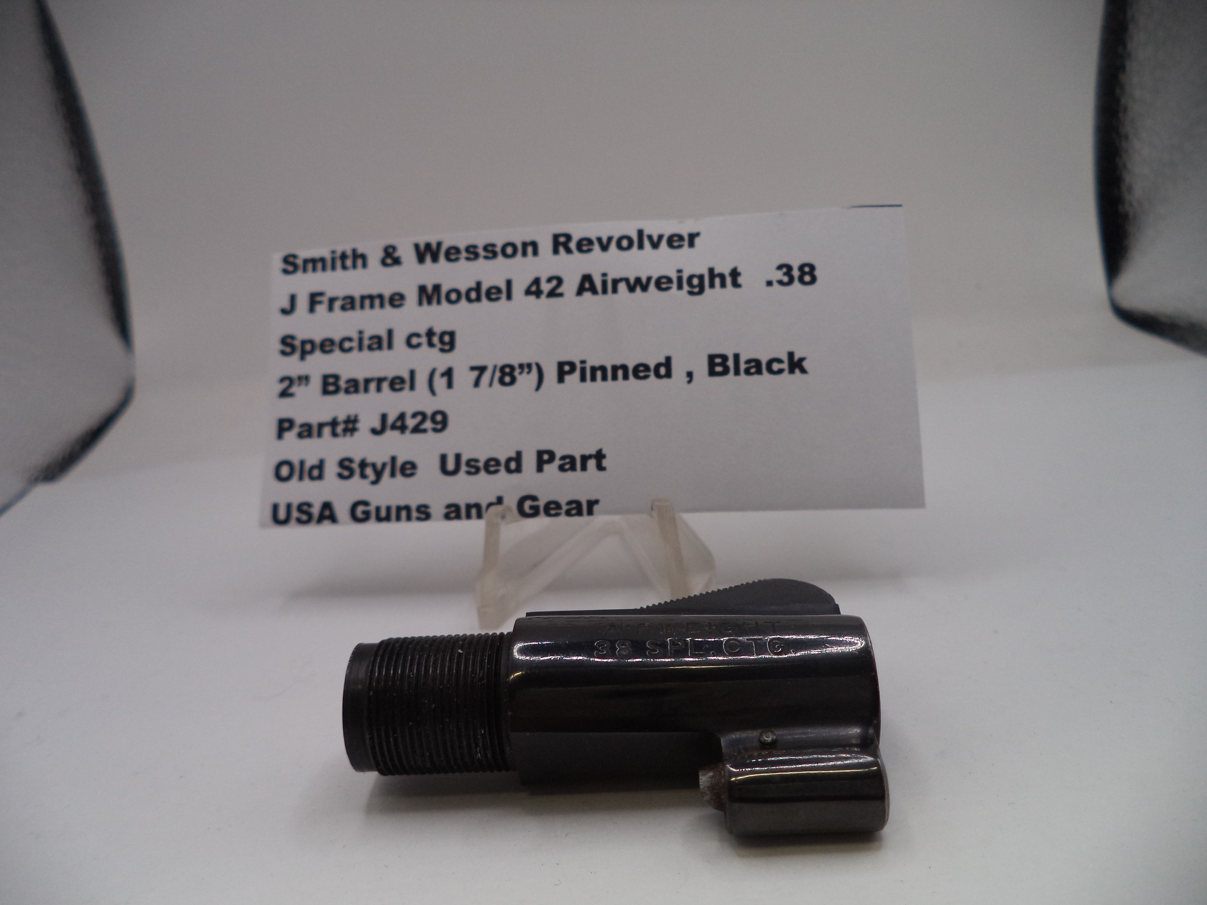 Smith & Wesson revolver part with descriptive card on a white background