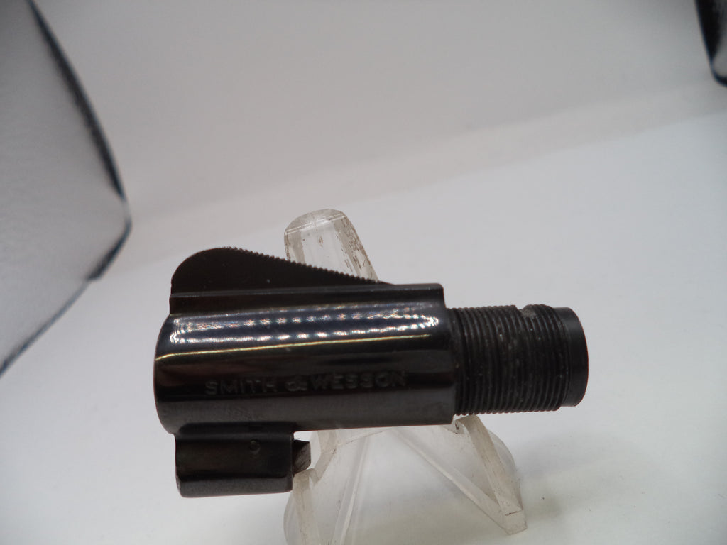 Black metal fitting on a clear stand against a white background