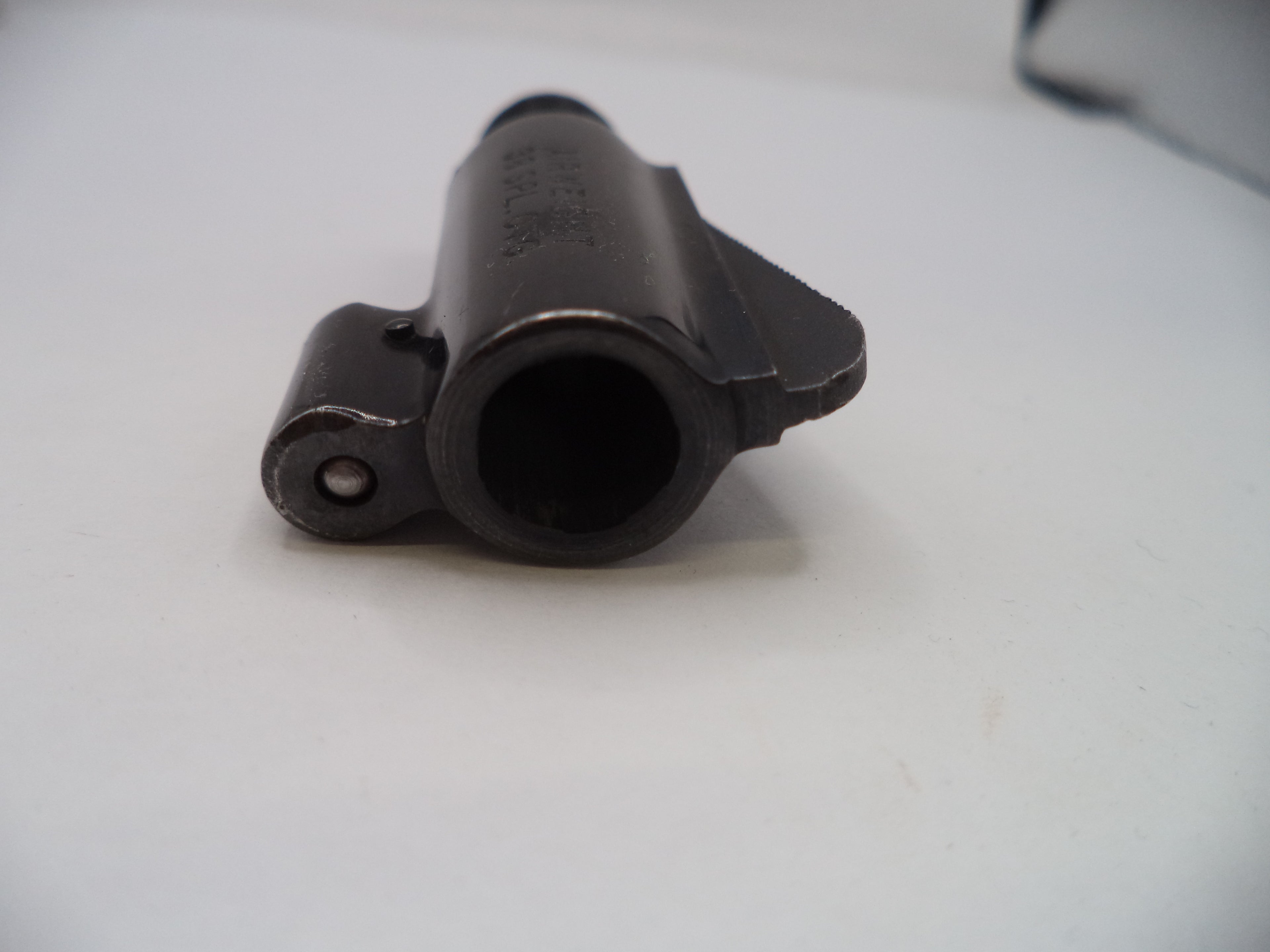 Black mechanical component on a white surface