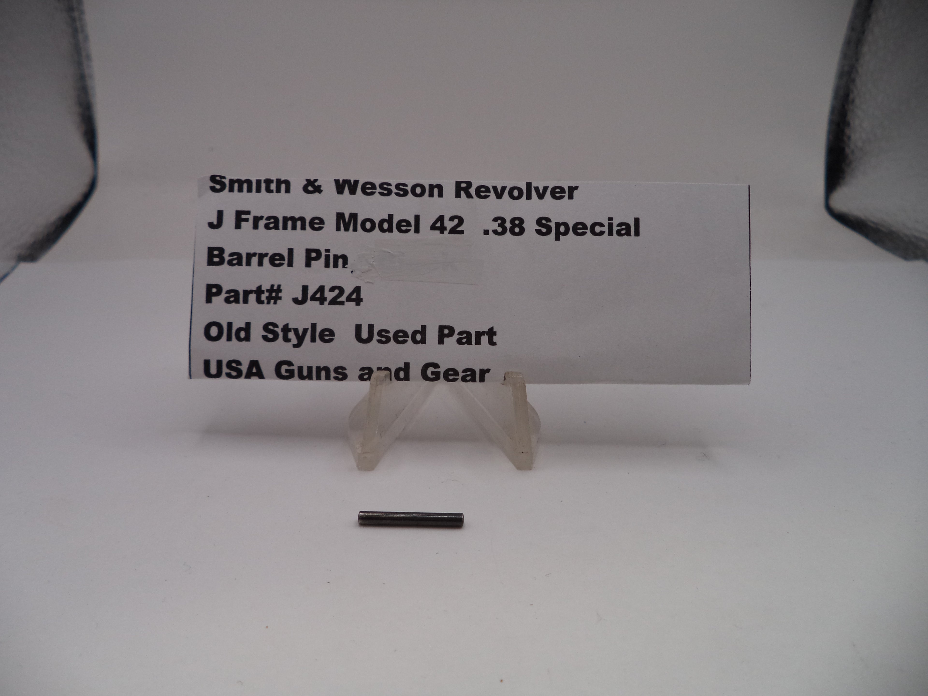 Smith & Wesson revolver barrel pin with a label on a white background