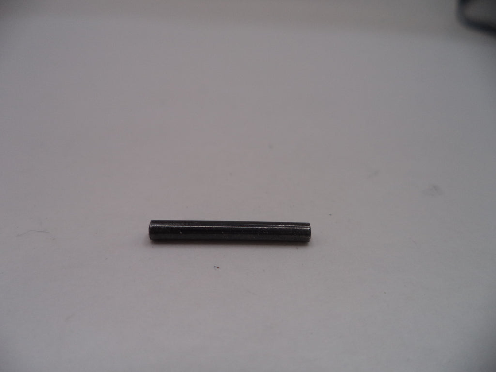 Small cylindrical black object on a light gray surface