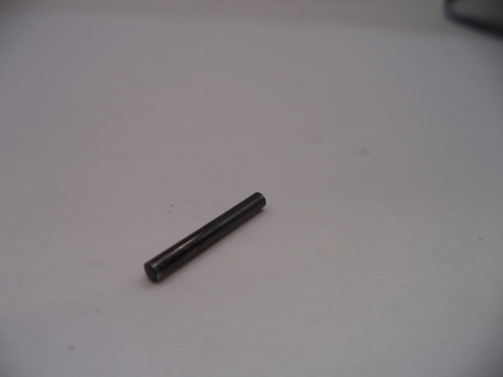 Small black cylindrical object on a white surface
