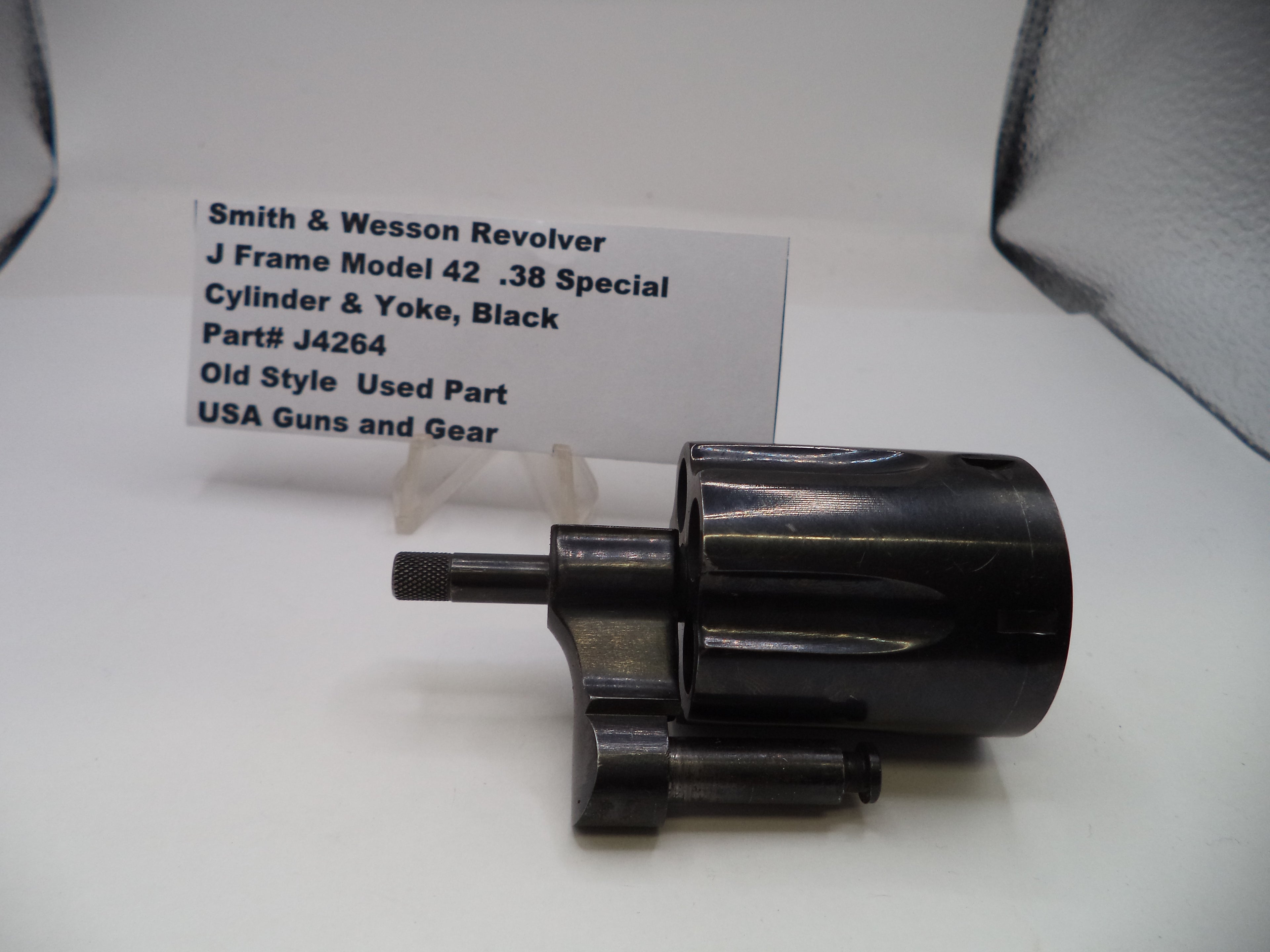 Black revolver cylinder and yoke with a label on a white background