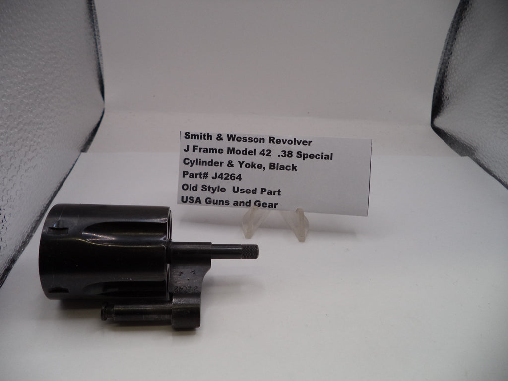 Smith & Wesson revolver cylinder and yoke on a white background with a label.