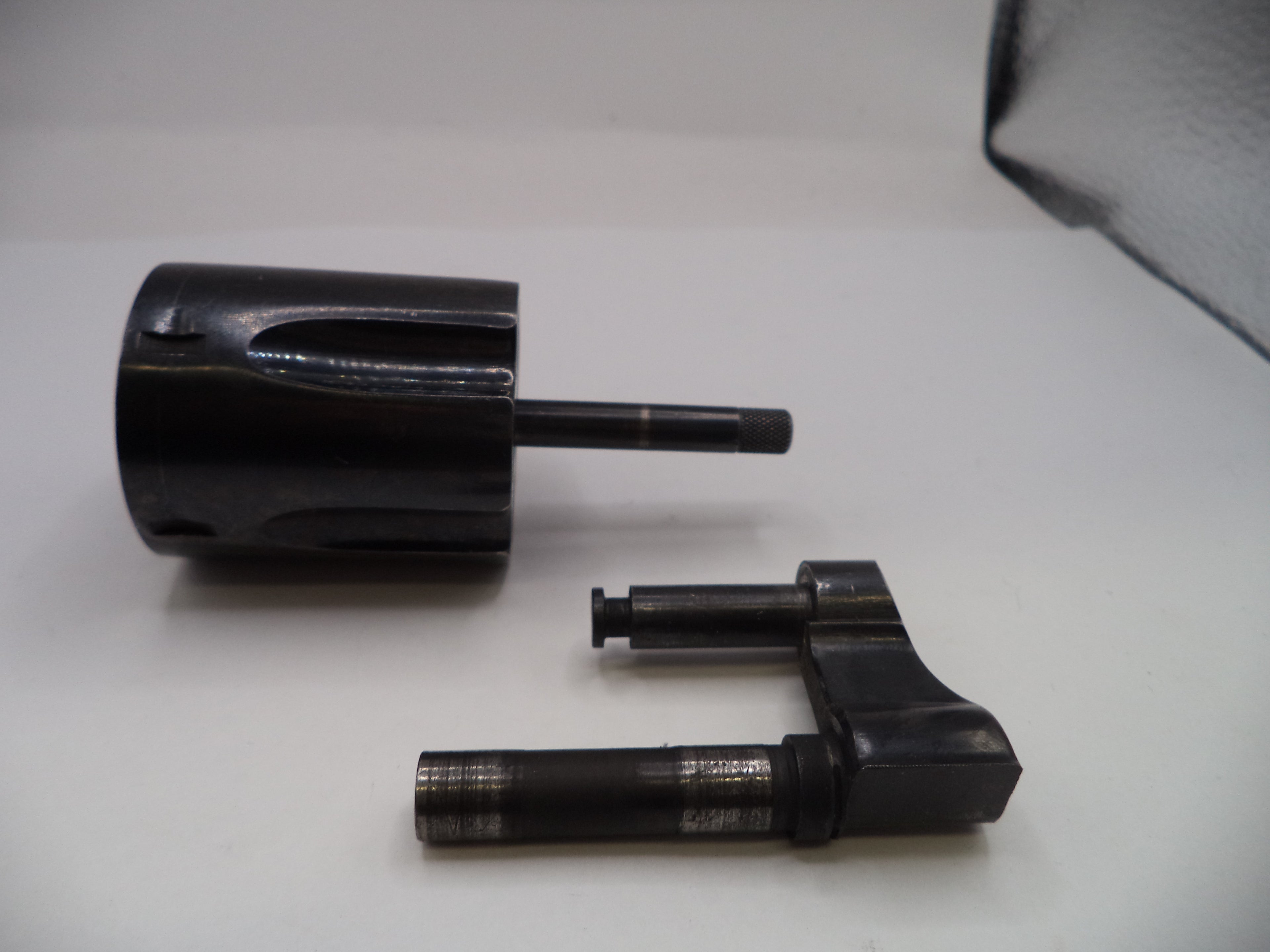 Black metal cylindrical components on a white background