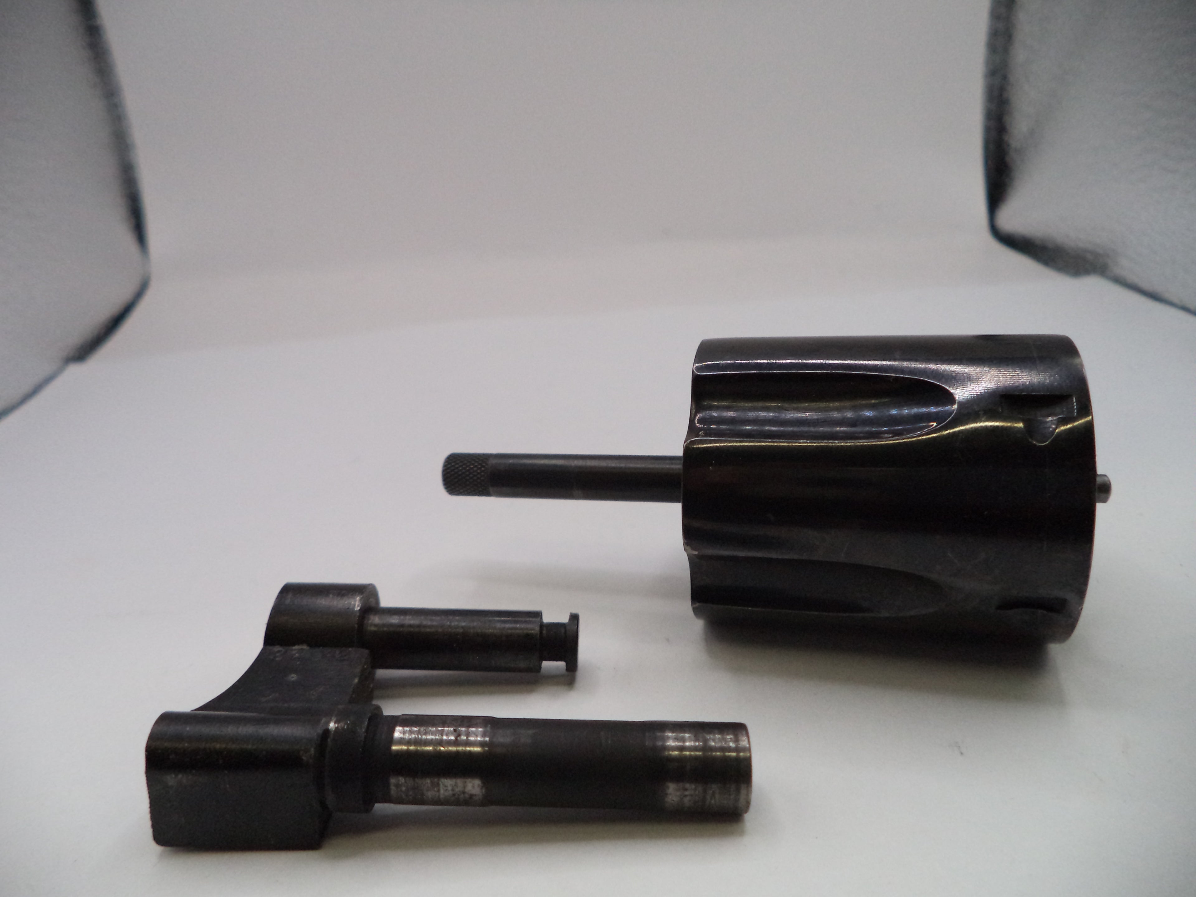 Two black mechanical components on a white background