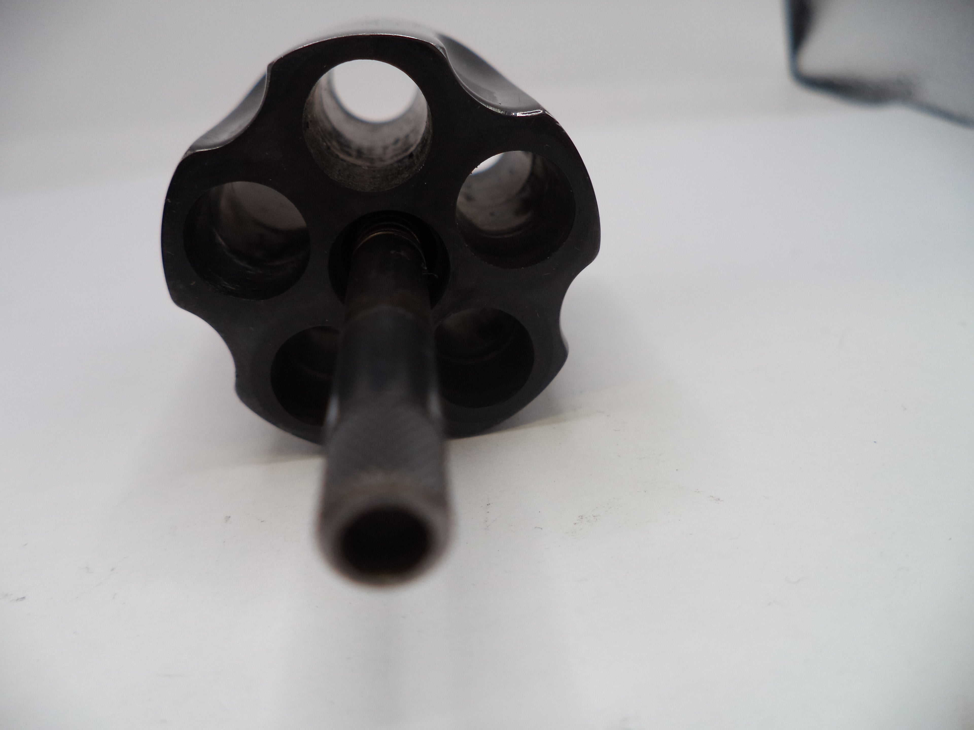 Black metal revolver barrel on a white background