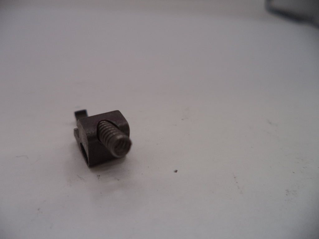 Small metal screw on a white surface