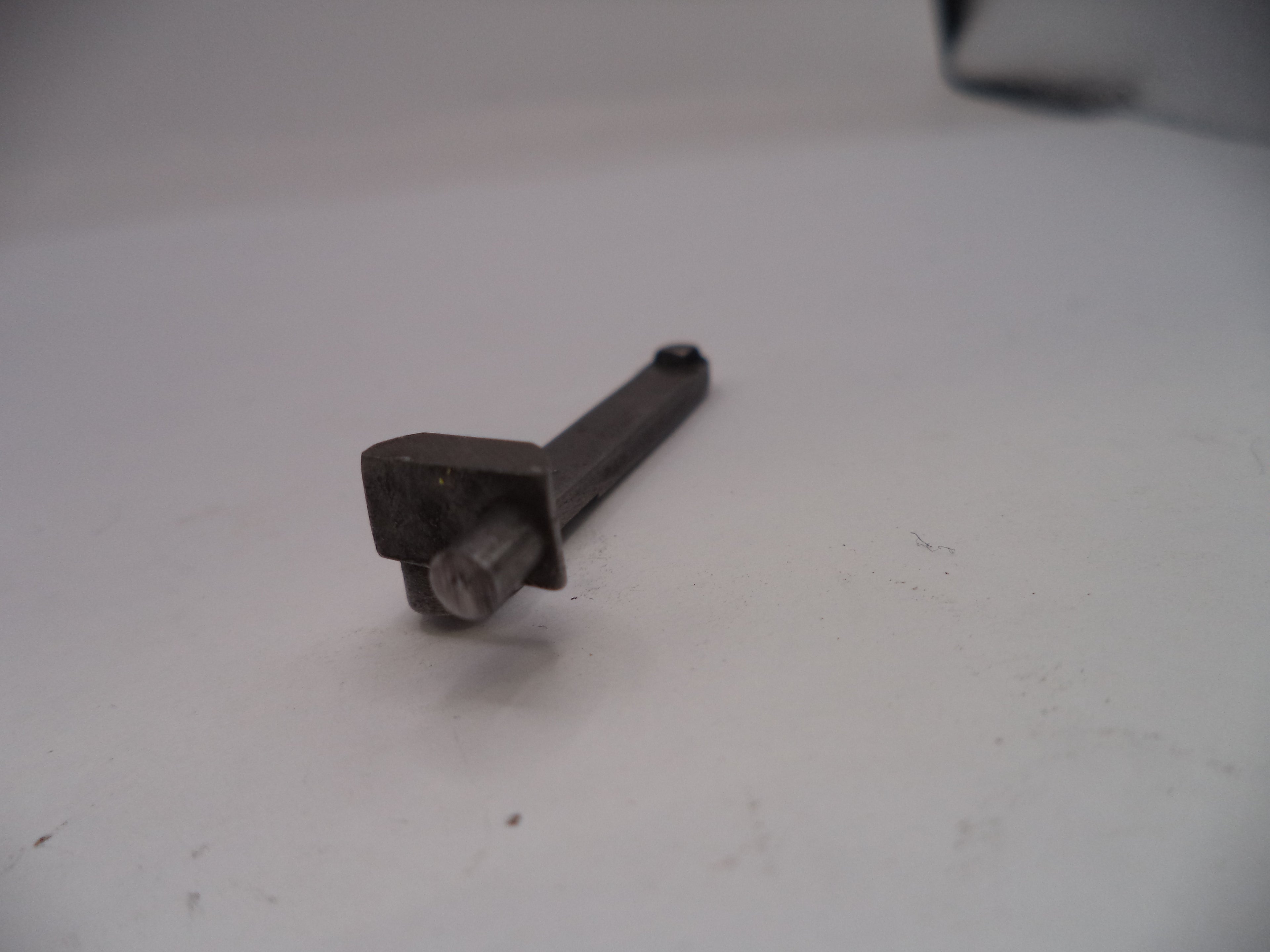Metal bolt on a white surface